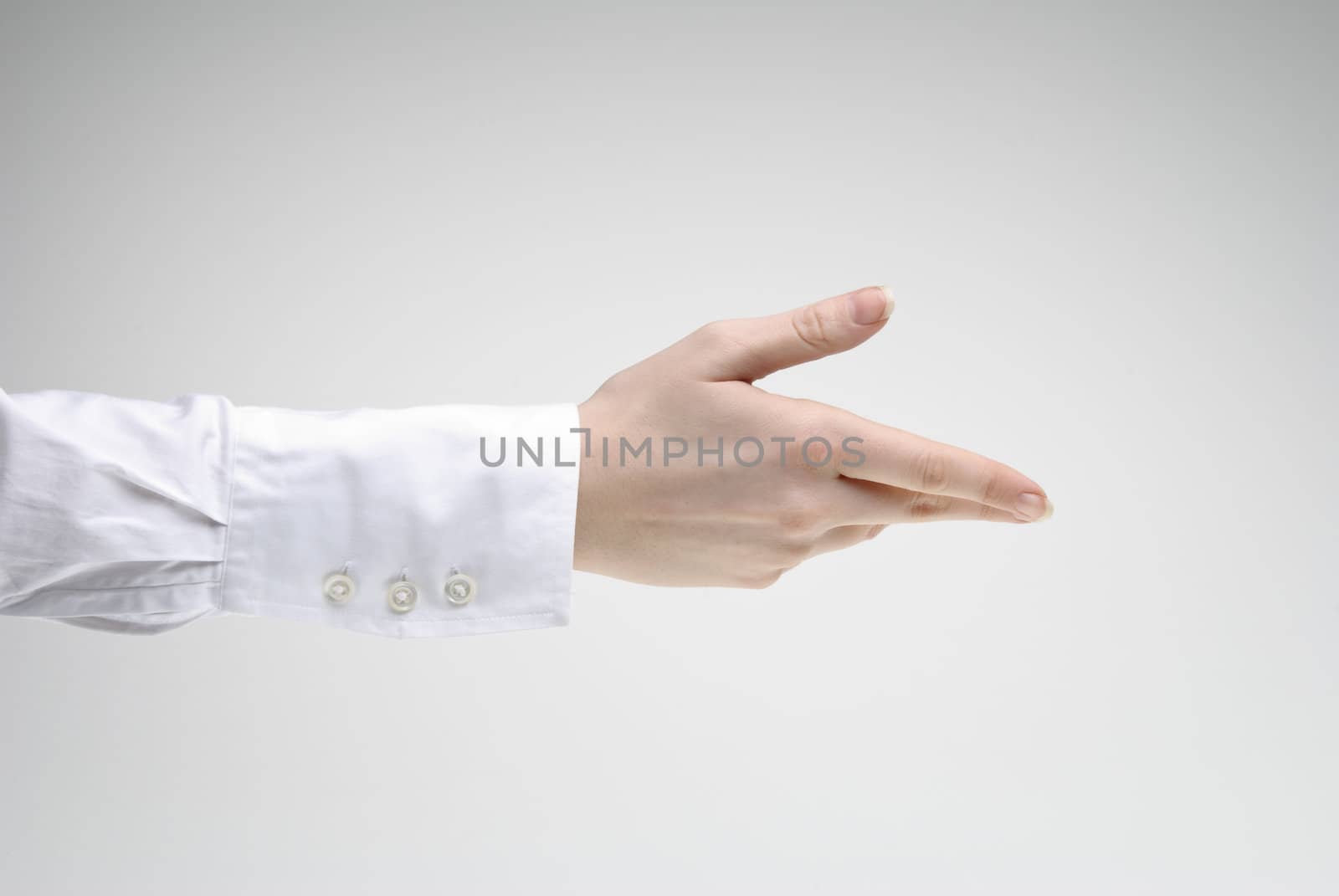 Woman extends a hand over light background