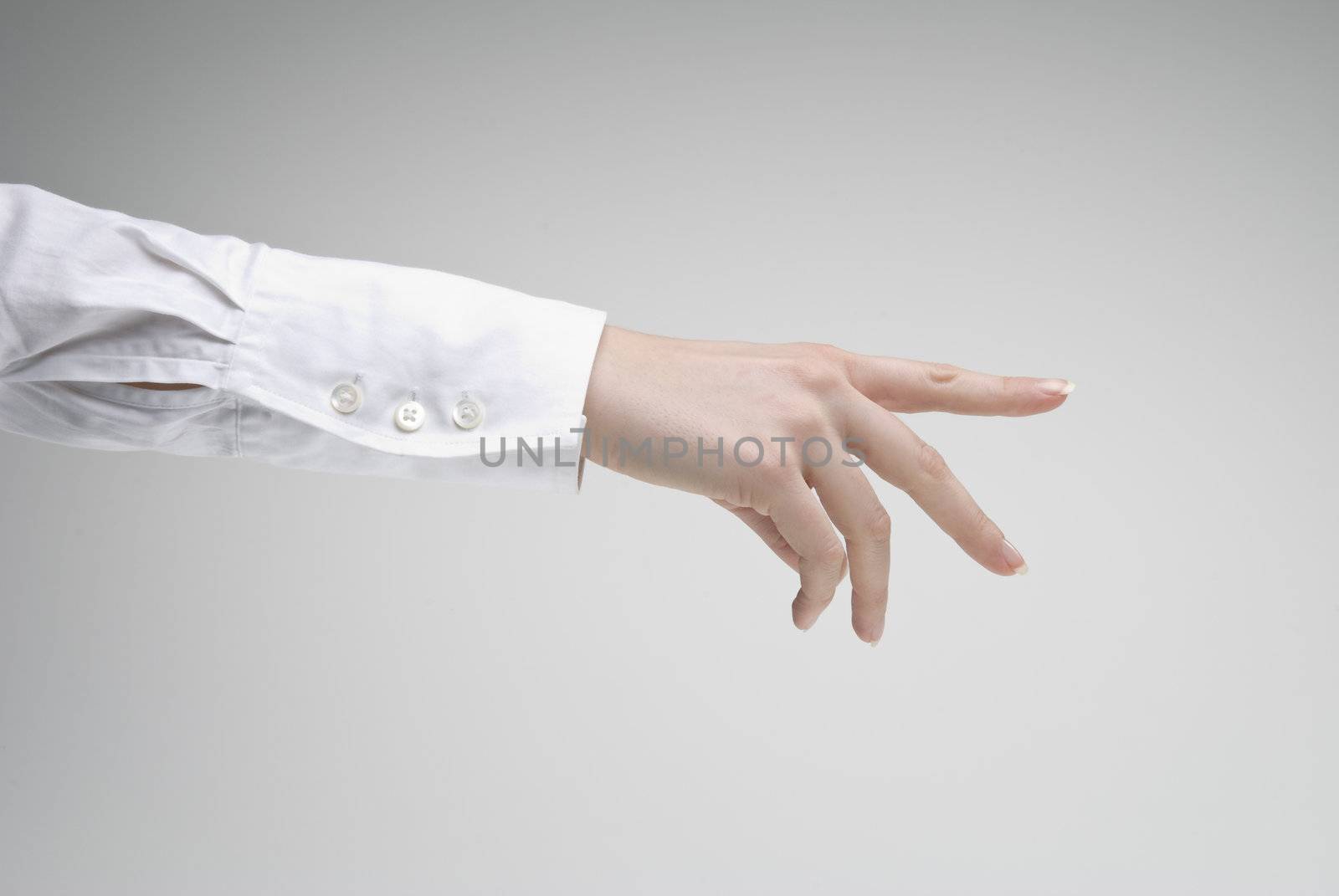 Woman extends a hand over light background