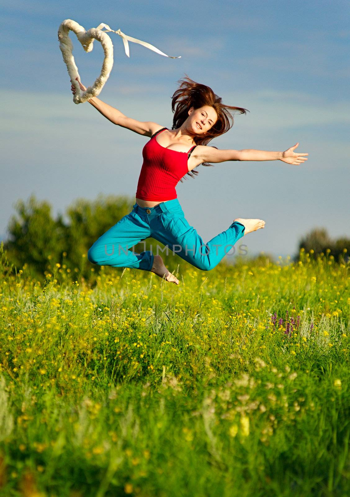 Sport woman running on a sunset field