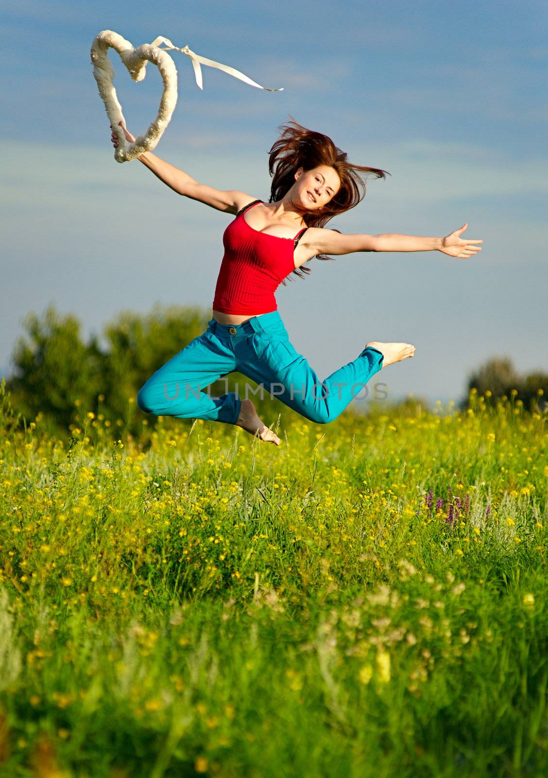 Sport woman running on a sunset field