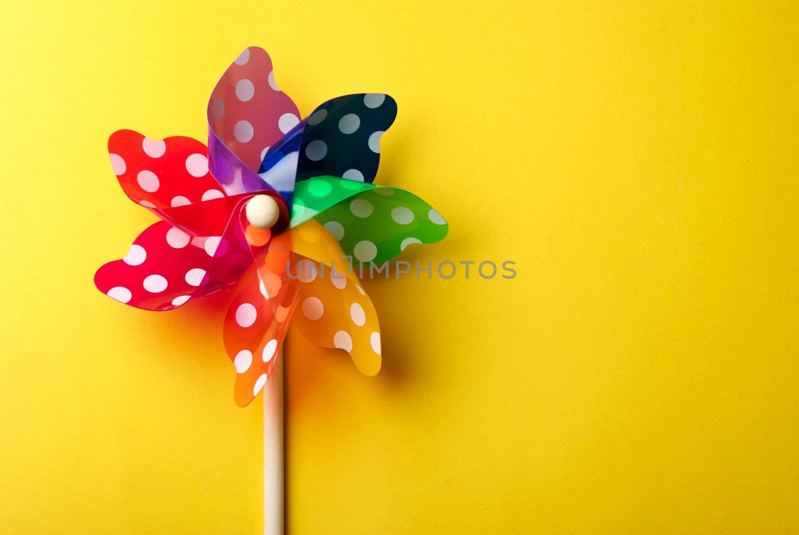 Windmill toy isolated on yellow background by kirs-ua