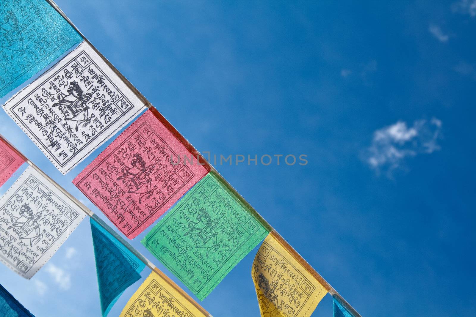 Buddhist tibetan prayer flags flying with blue sky