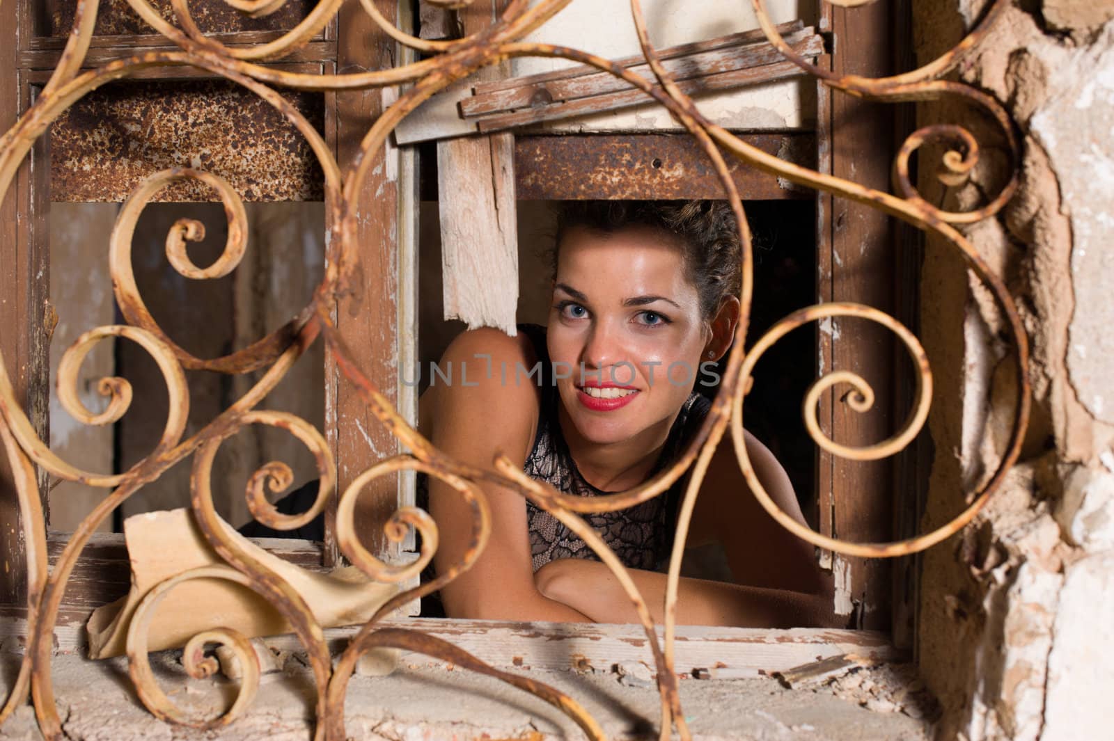 Portrait of a smiling woman inside a derelict ruin