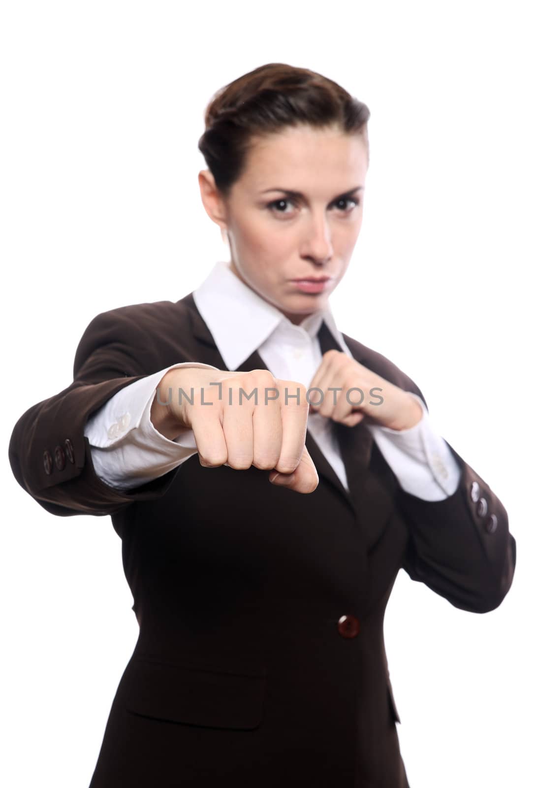 Portrait of an attractive young businesswoman punching. Isolated on white background