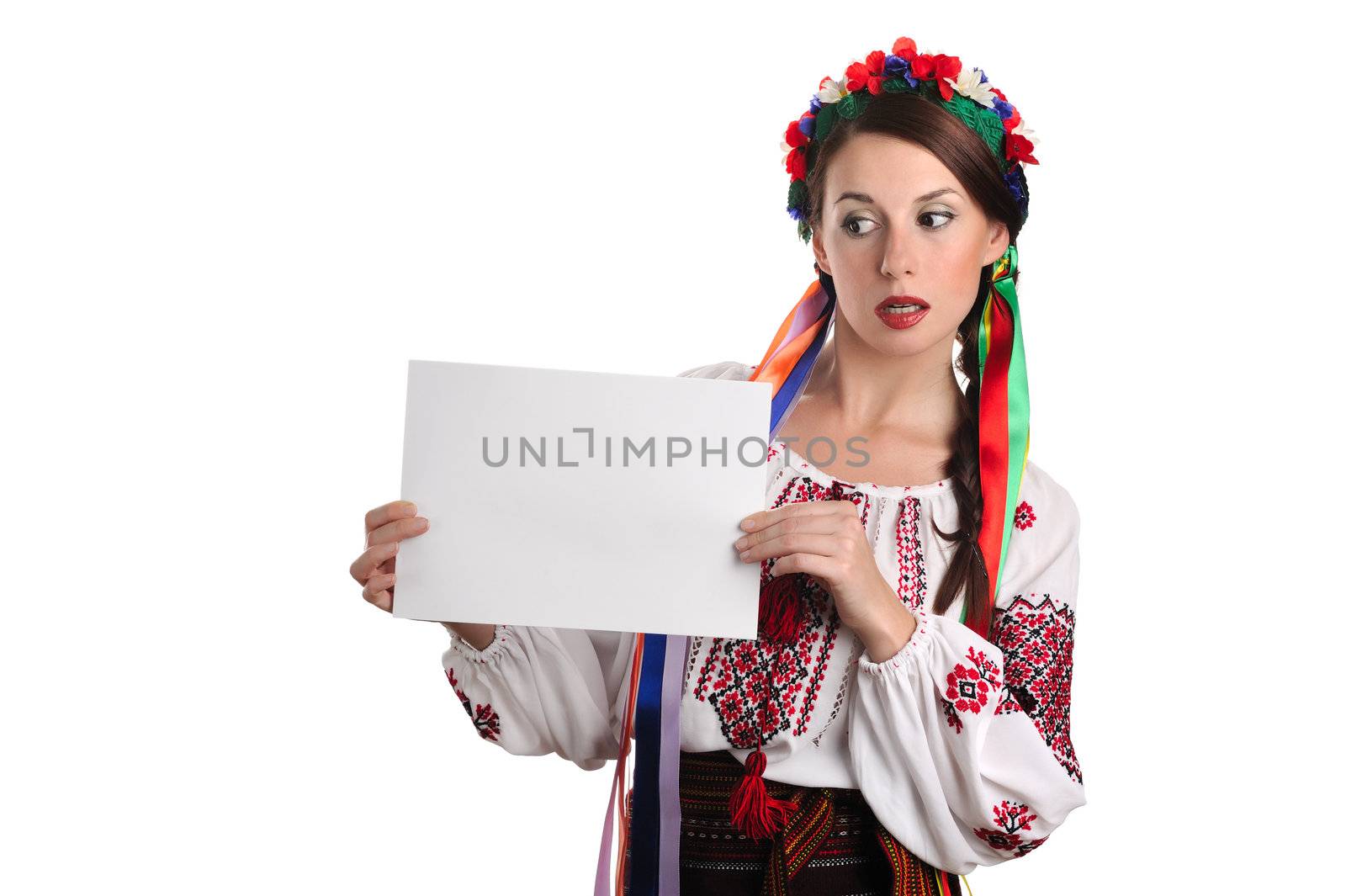 Young Ukrainian woman in national costume showing empty sheet of paper. Isolated on white background