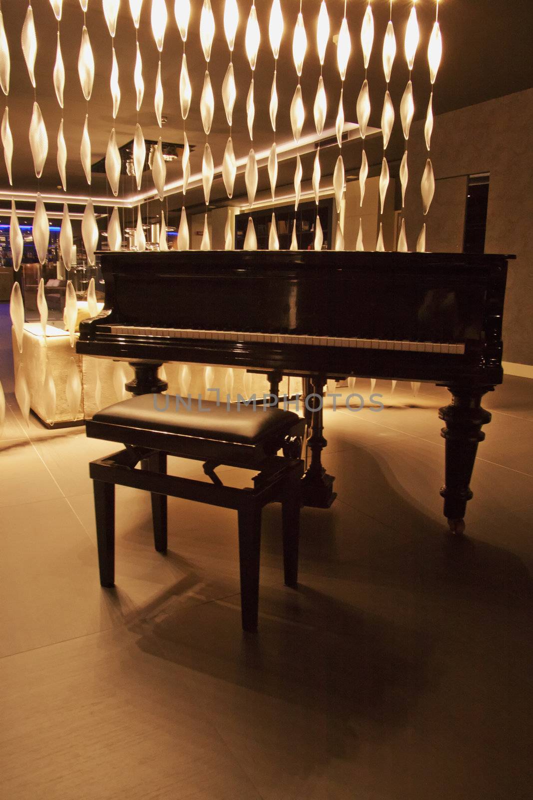 An elegant black piano in a lobby