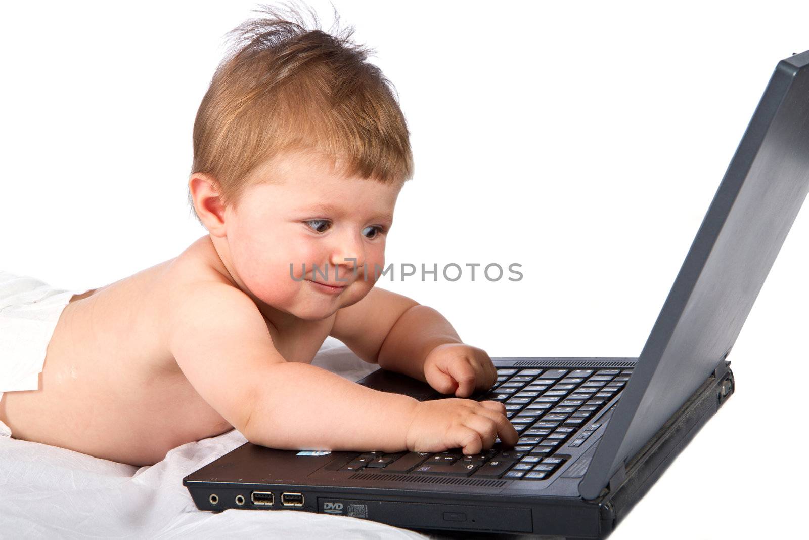 Child playing with  a laptop by lsantilli
