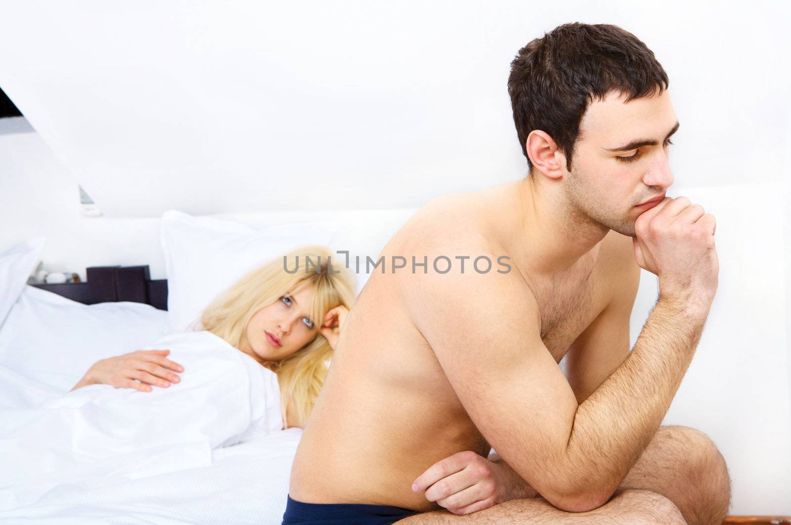 problems of a young couple in bedroom, focus on male