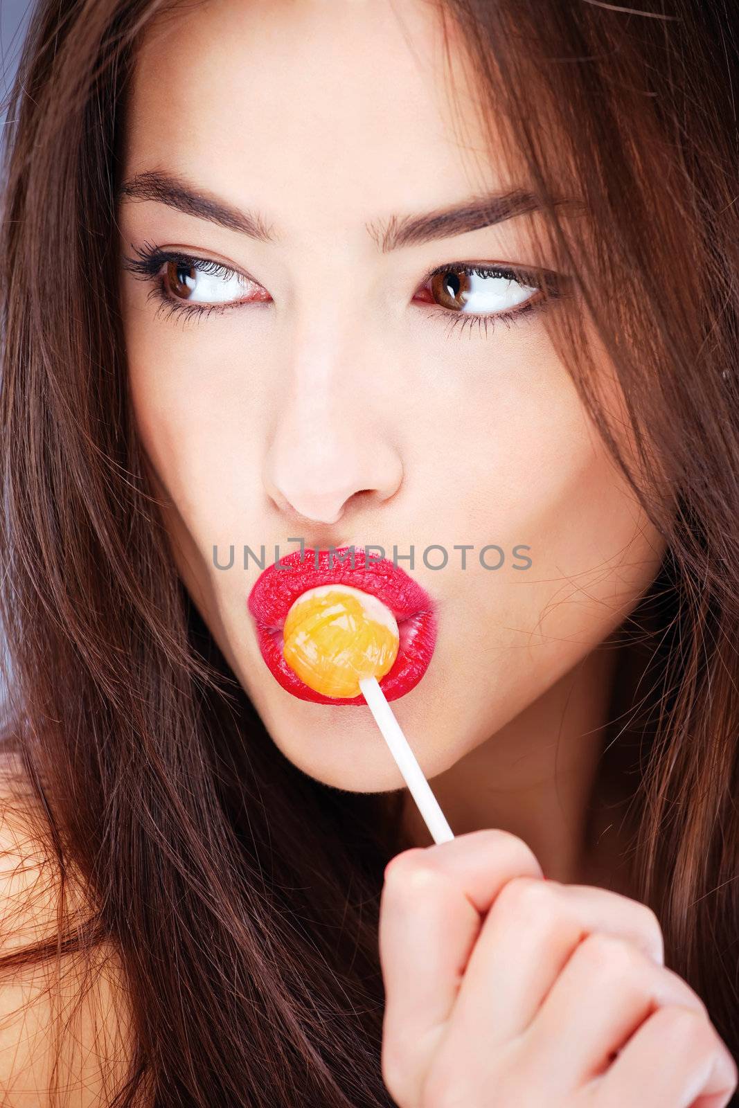 Pretty woman with lollipop on her lips
