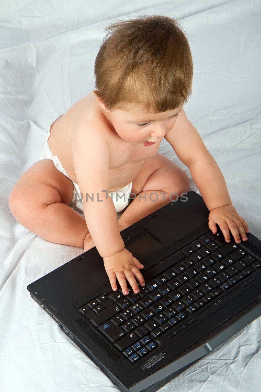 Child playing with  a laptop