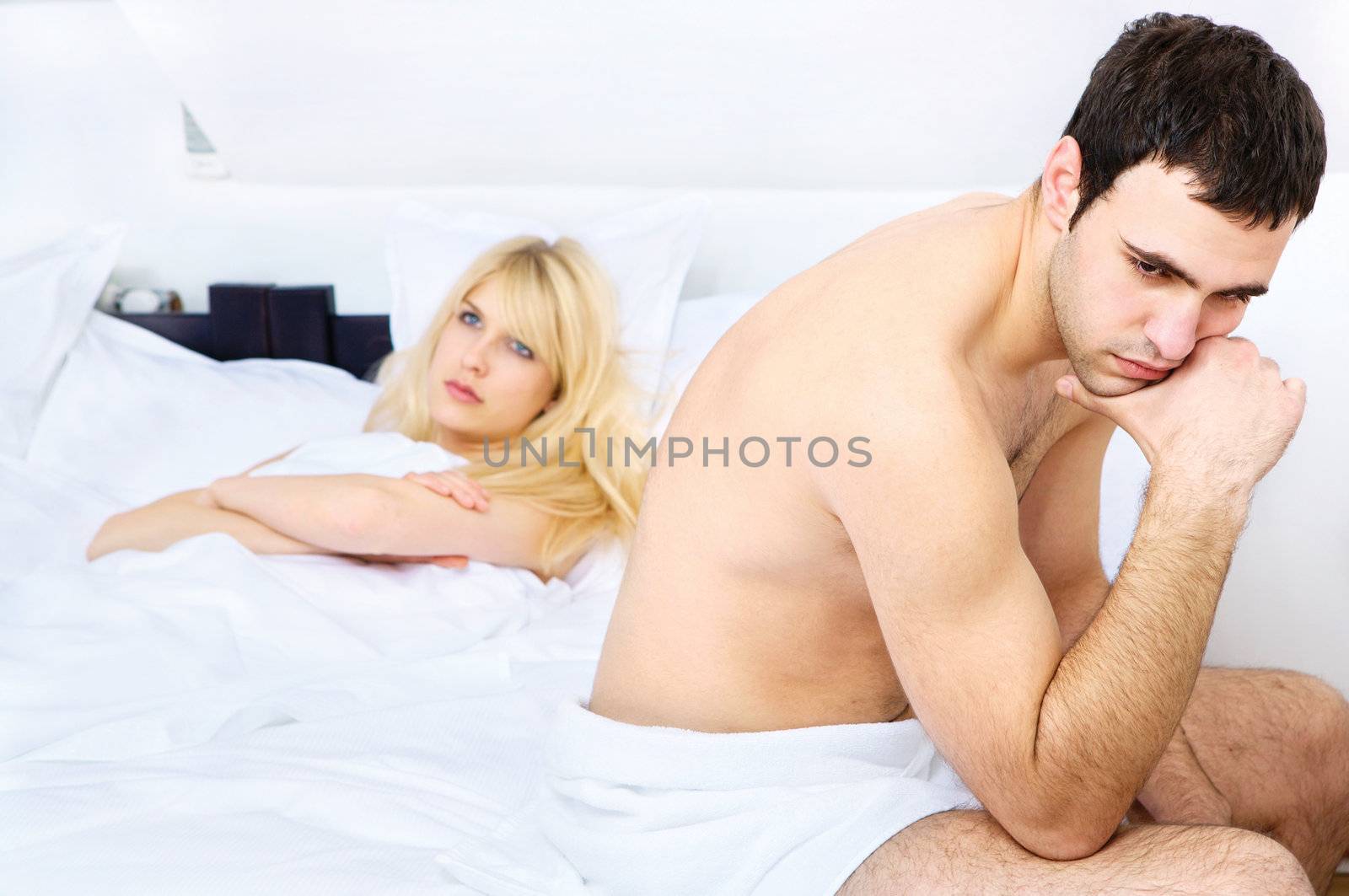 relationship difficulties of a young couple in bedroom, focus on male