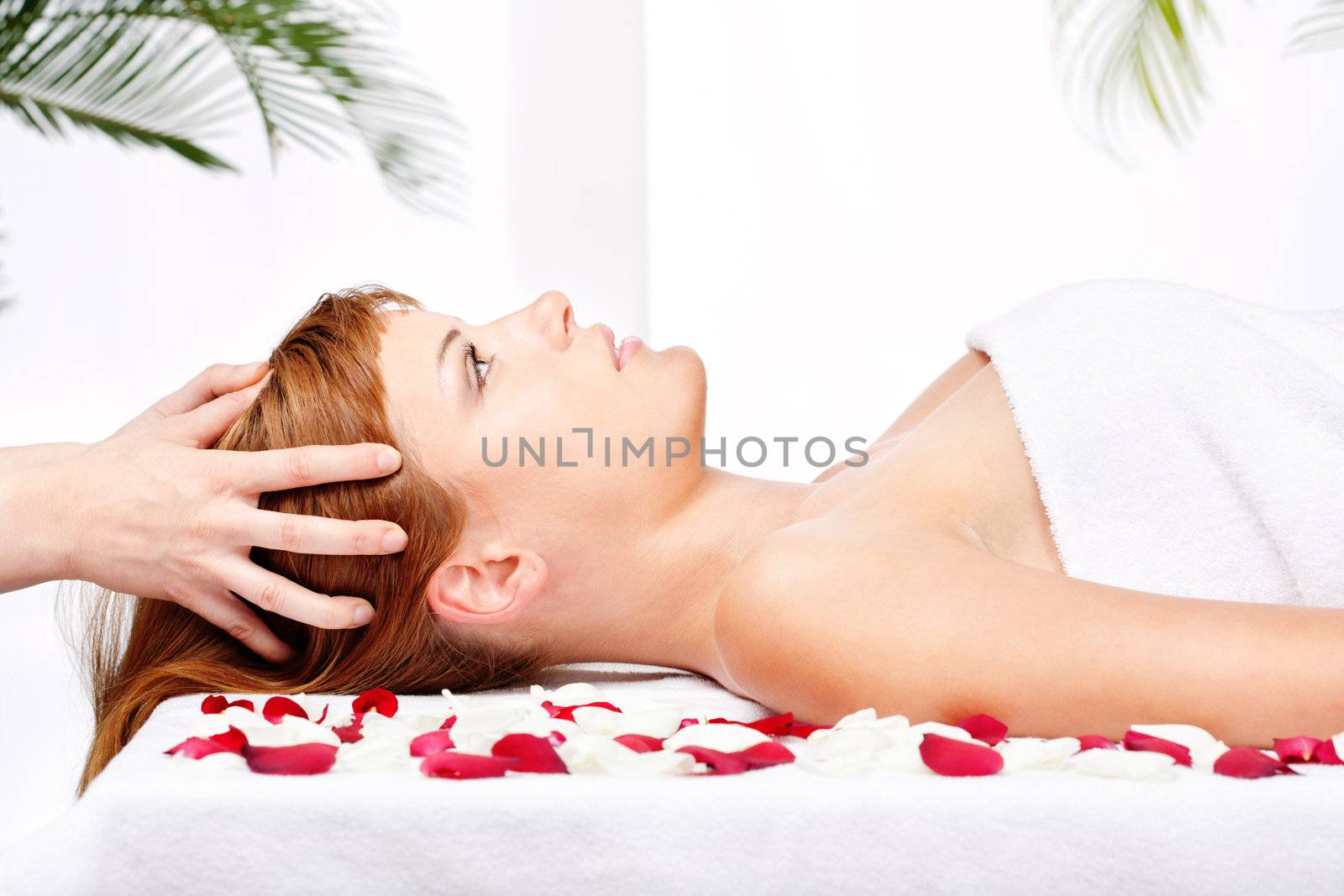 woman on head massage treatment in salon by imarin