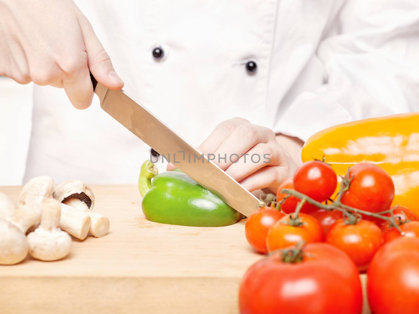 chef cutting bell peppers on board