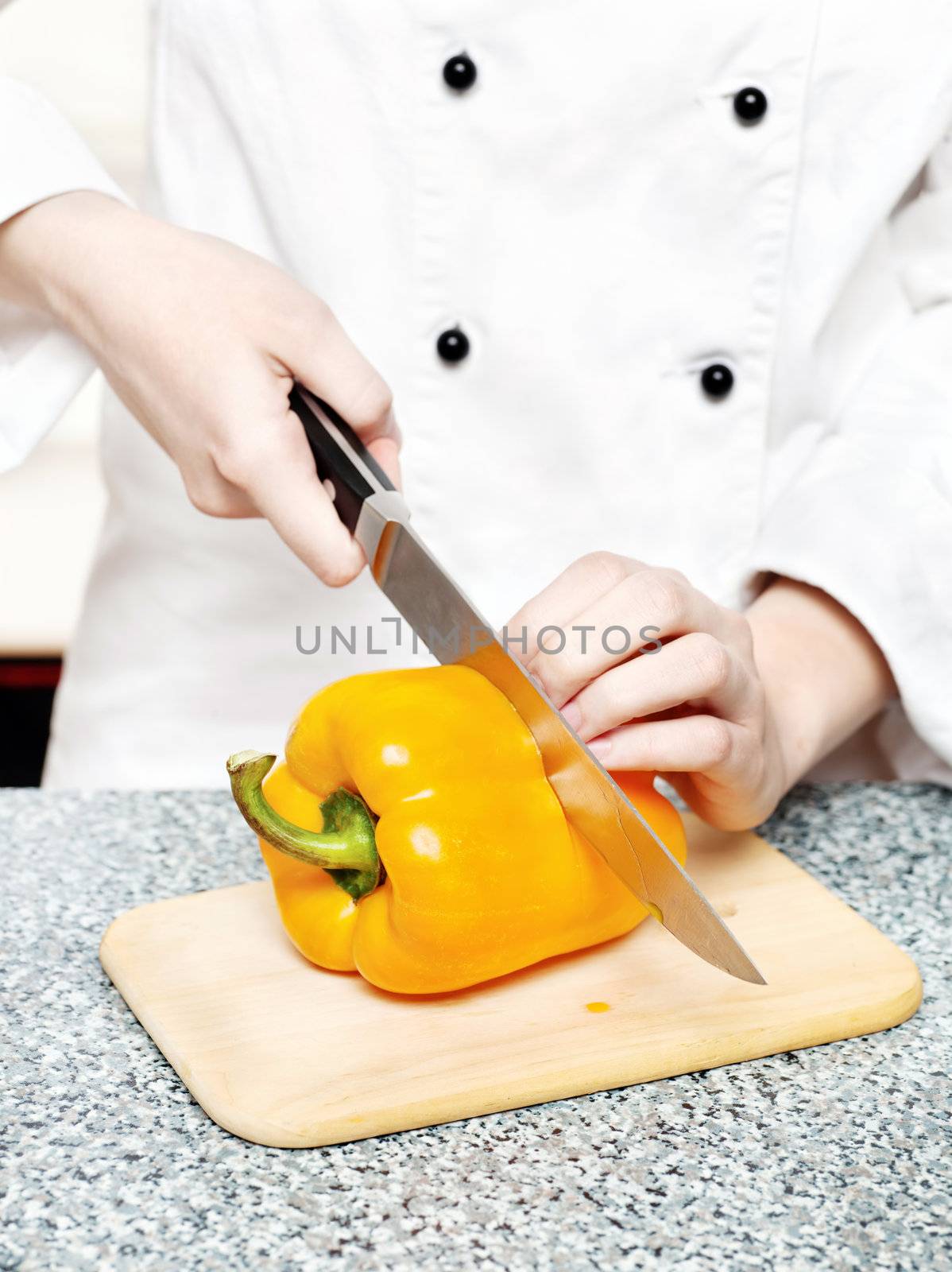 chef cutting bell peppers on board