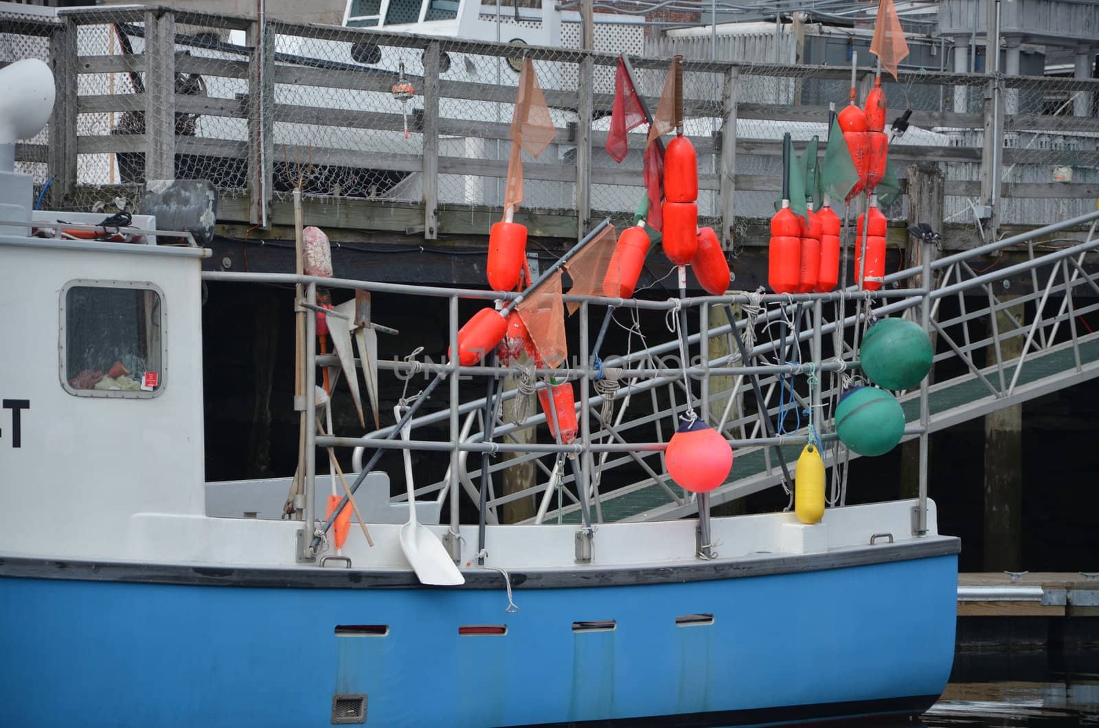 A lobster boat at the dock getting ready to head out.