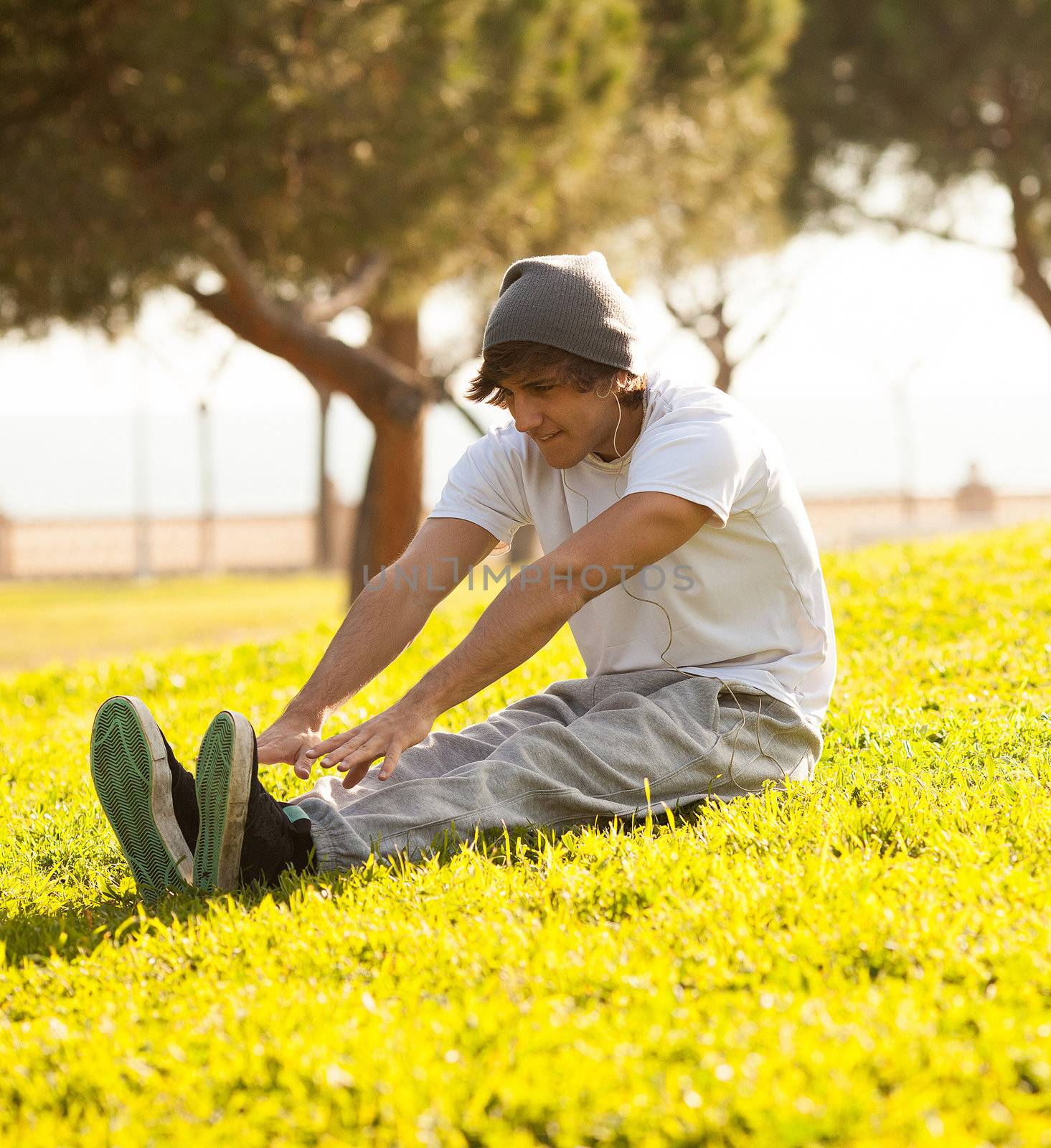 young man portrait stretching after jogging by Lcrespi