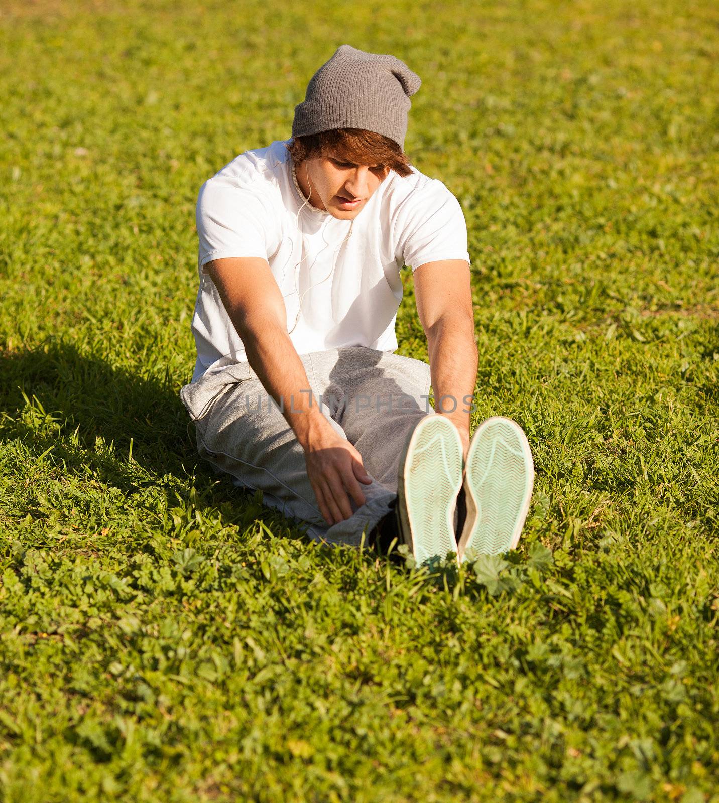 young man portrait stretching after jogging by Lcrespi