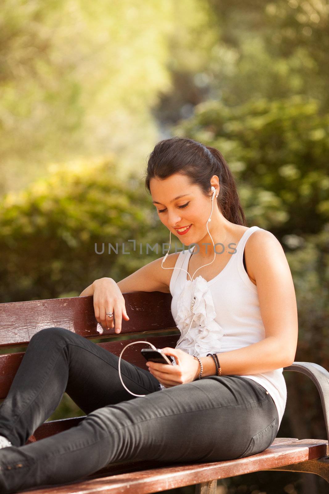 young latin woman using celphone  by Lcrespi