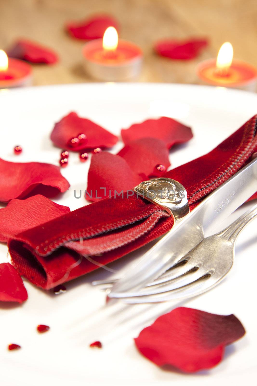 place setting for valentines day with petals