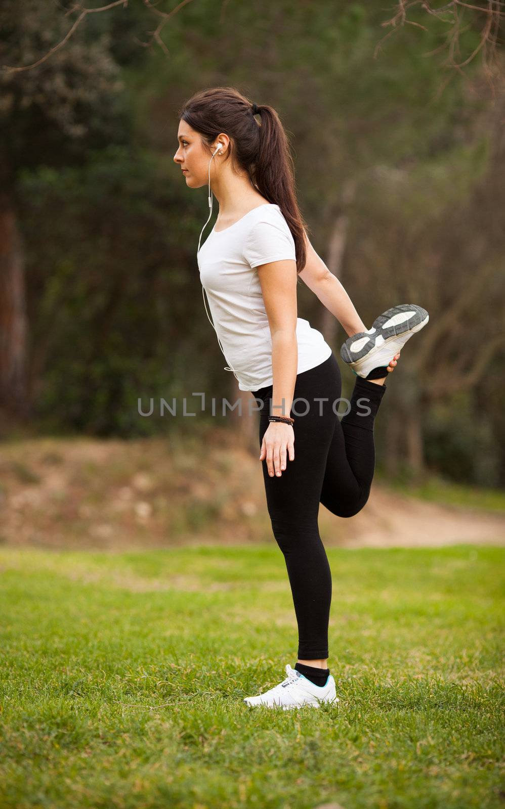 young beautiful woman stretching outdoors