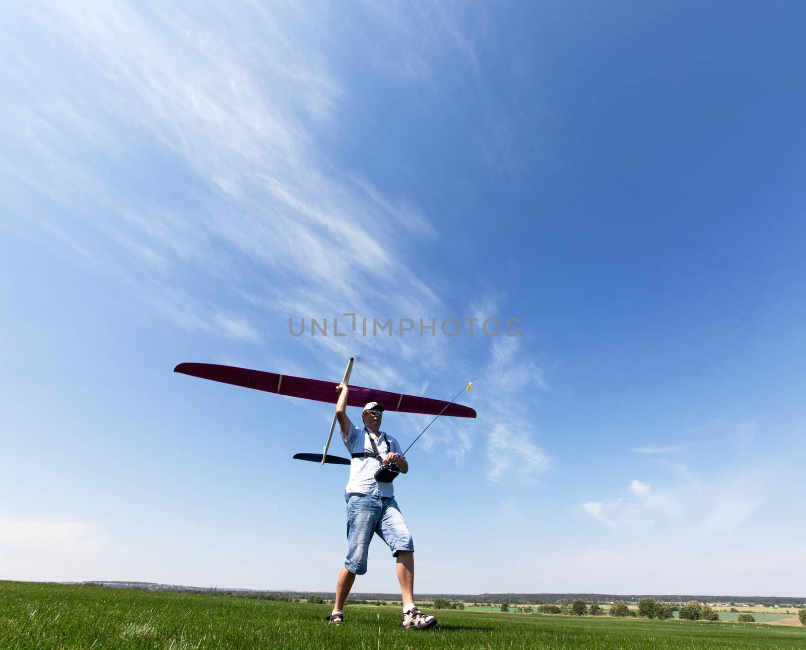 Man launches into the sky RC glider, wide-angle