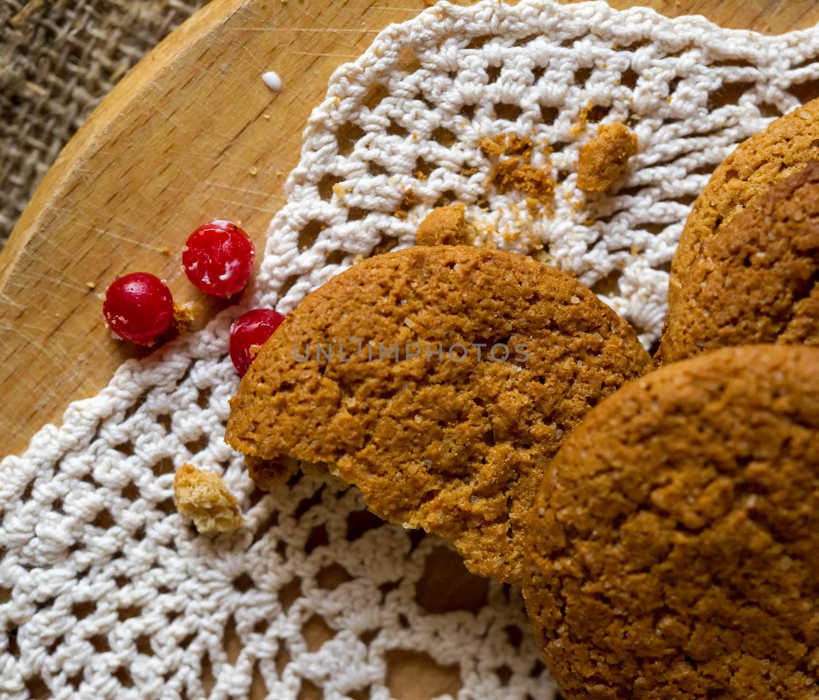 Crumpled tasty oatmeal cookies with cranberries on knitting cloth.Shallow DOF