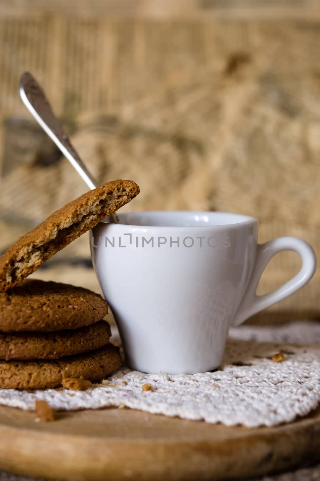 Crumbling oat cookies biscuits with cup of coffee. Shallow DOF