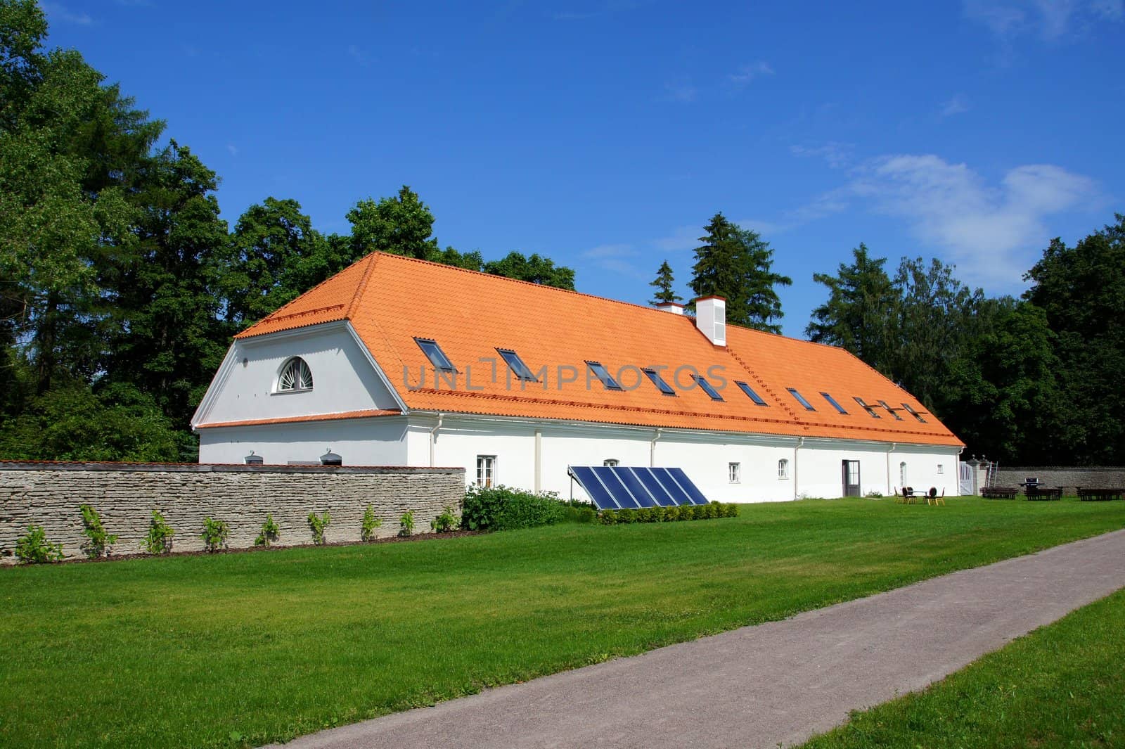 The long house on a background of green trees