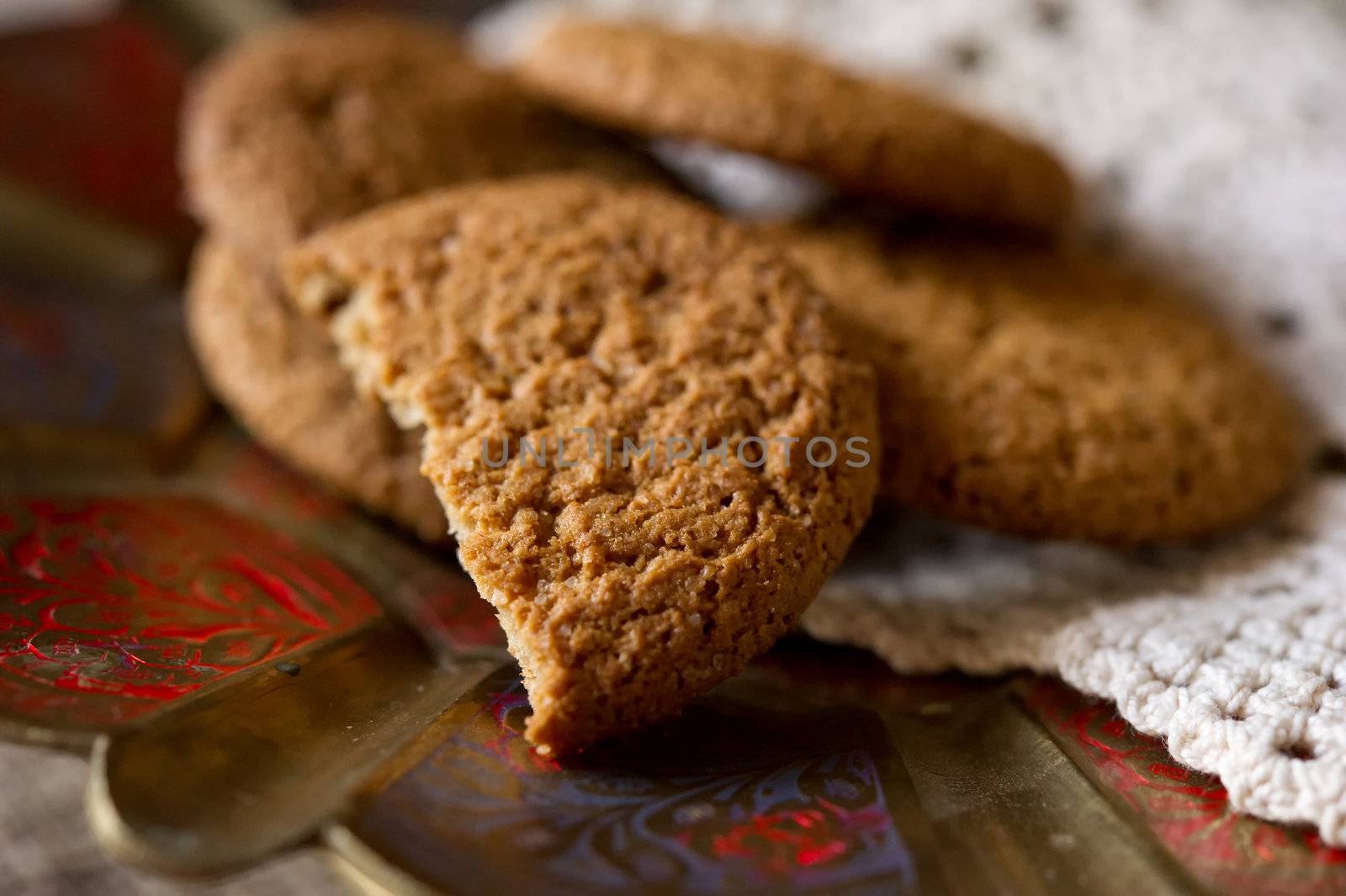 Crumpled tasty oatmeal cookies with cranberries on knitting cloth