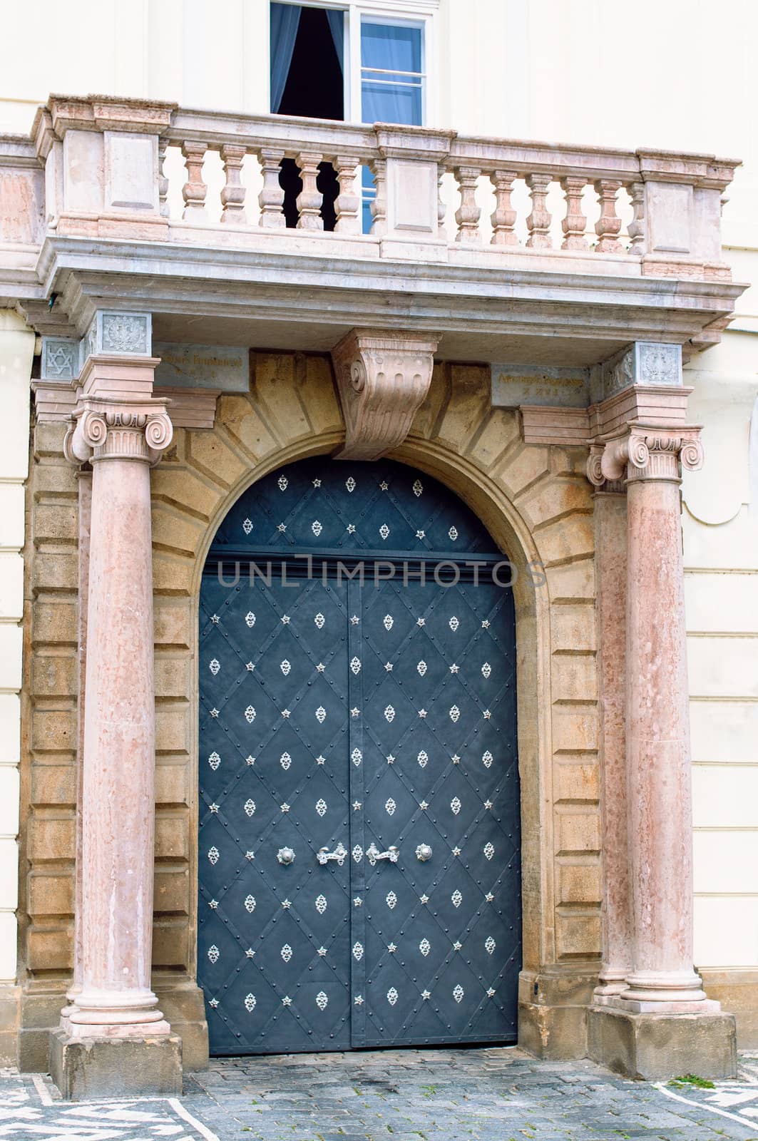 Traditional medieval european door with columns and balcony on street Prague