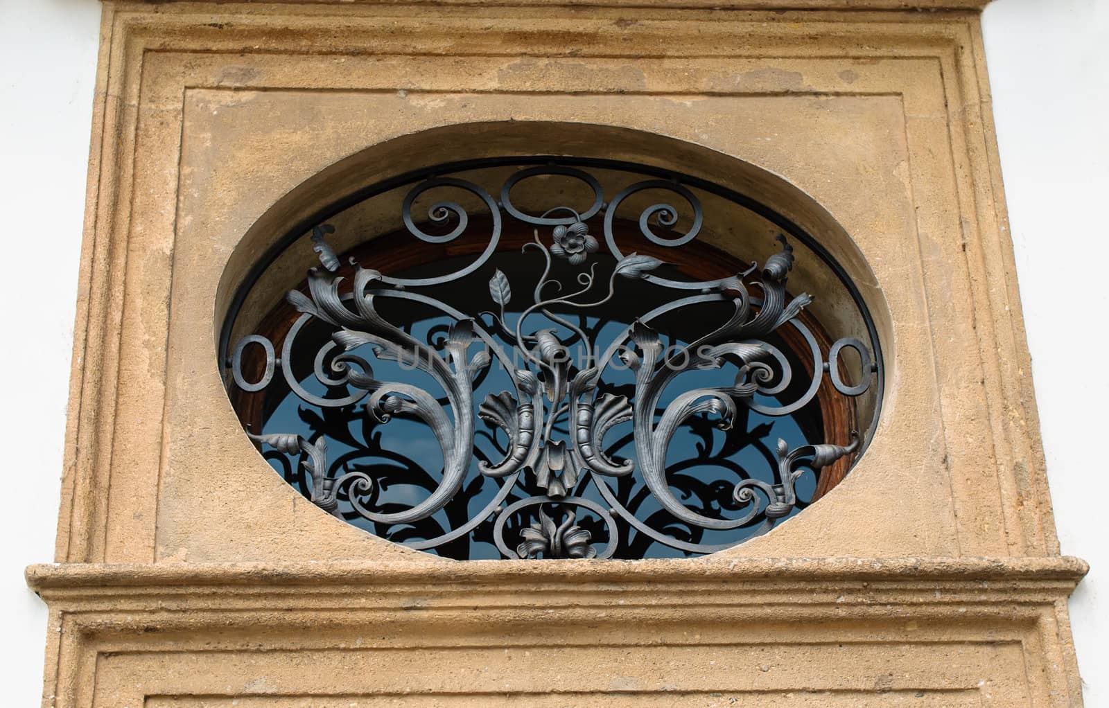 The beautiful forged on an oval window on street Prague