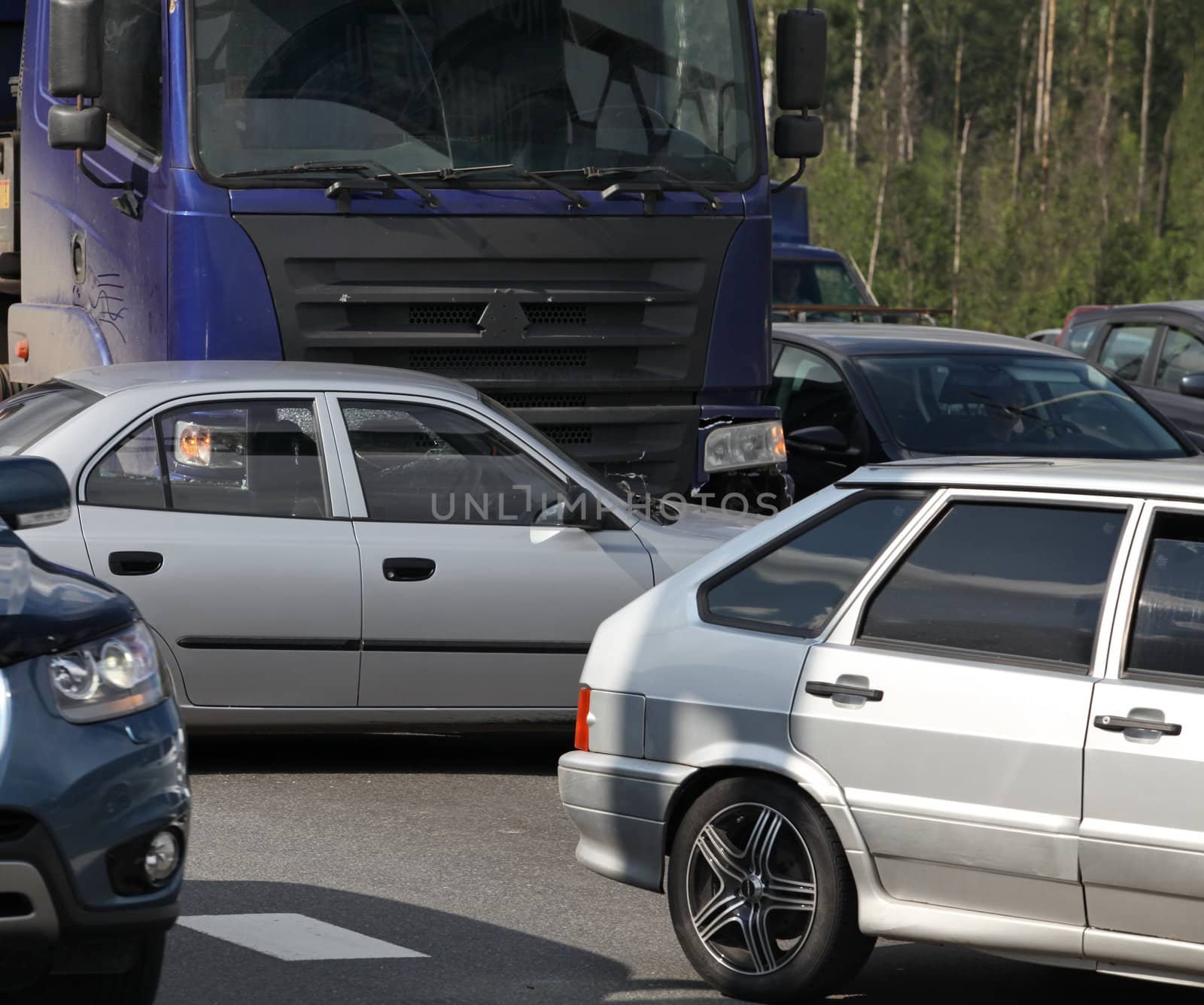 collision of the truck and car on a busy road