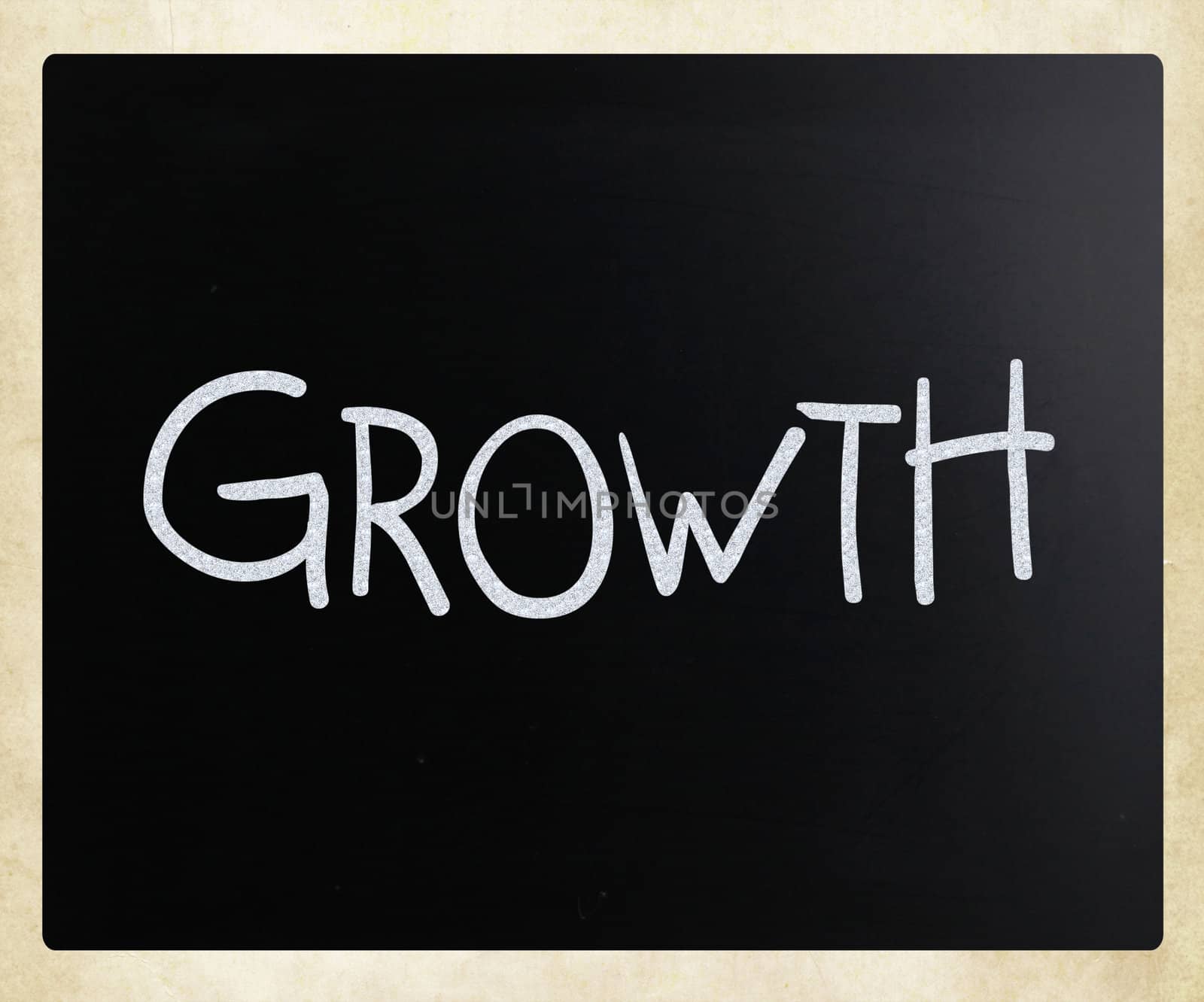"Growth" handwritten with white chalk on a blackboard by nenov