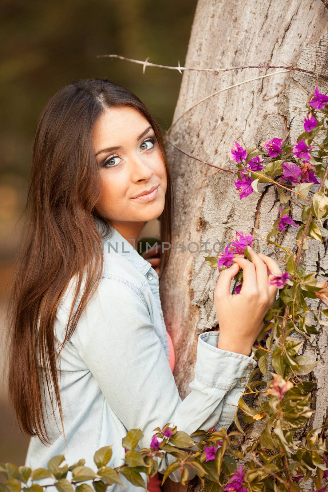 young beautiful teen woman smells flowers