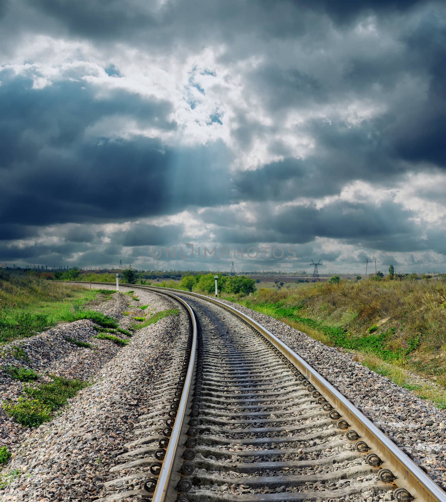 railroad to horizon and dramatic sky by mycola