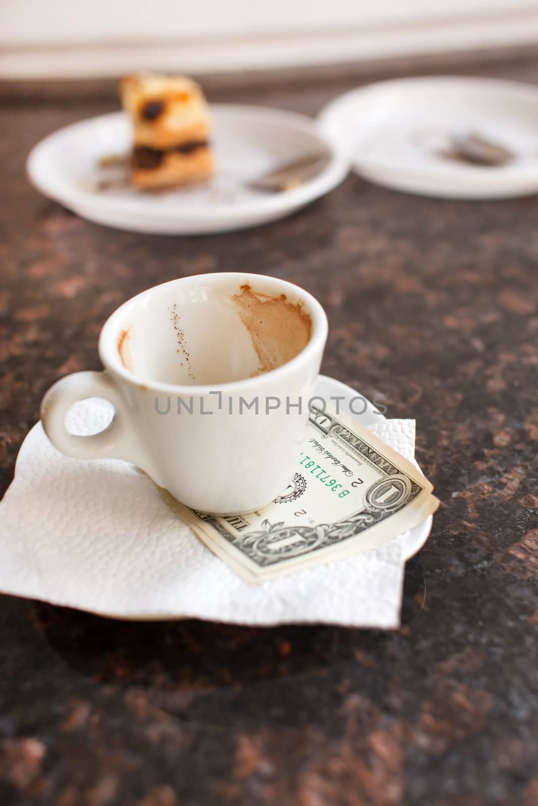 dollar bills under a coffee cup  by shebeko