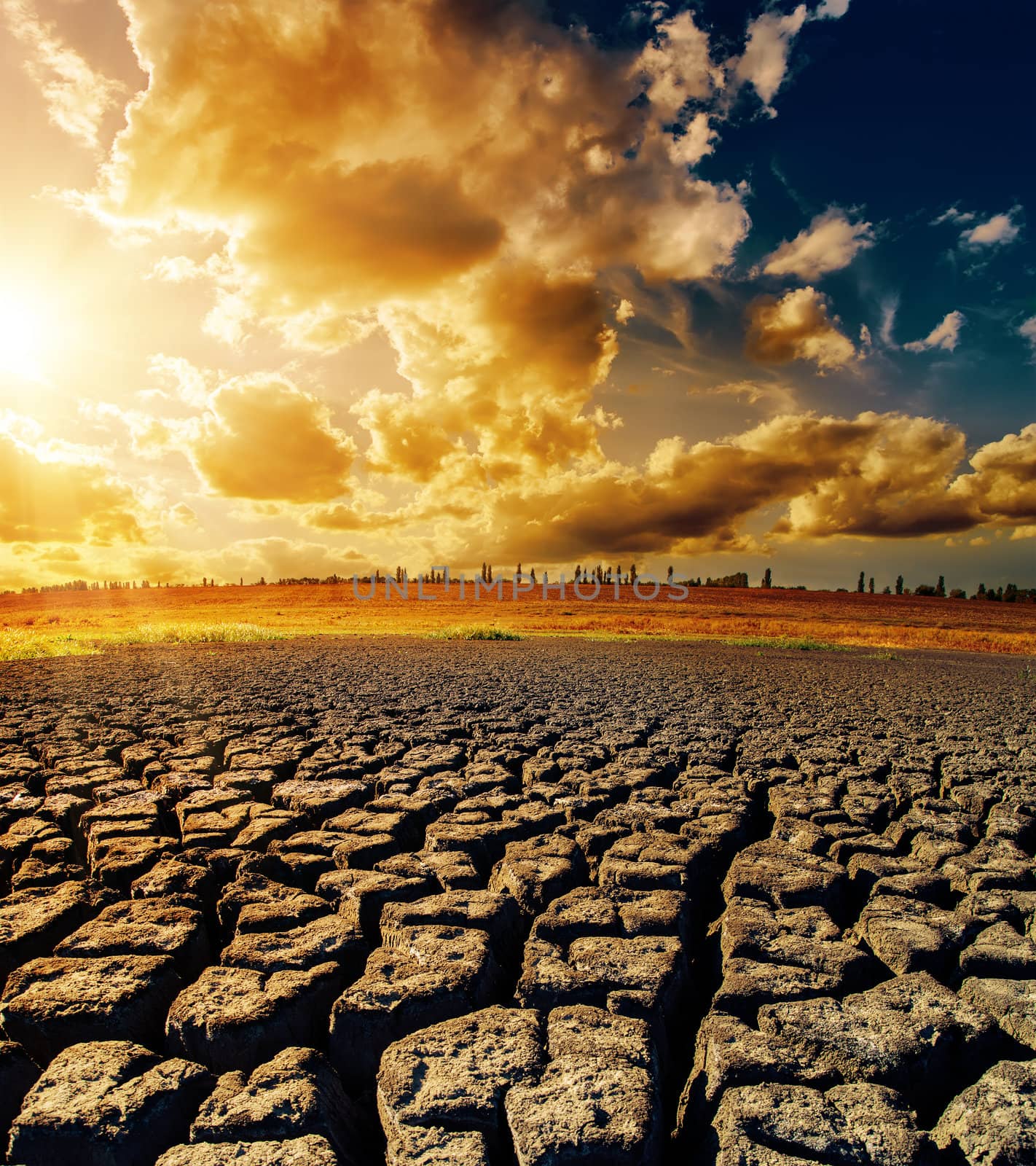 dramatic sunset over drought earth