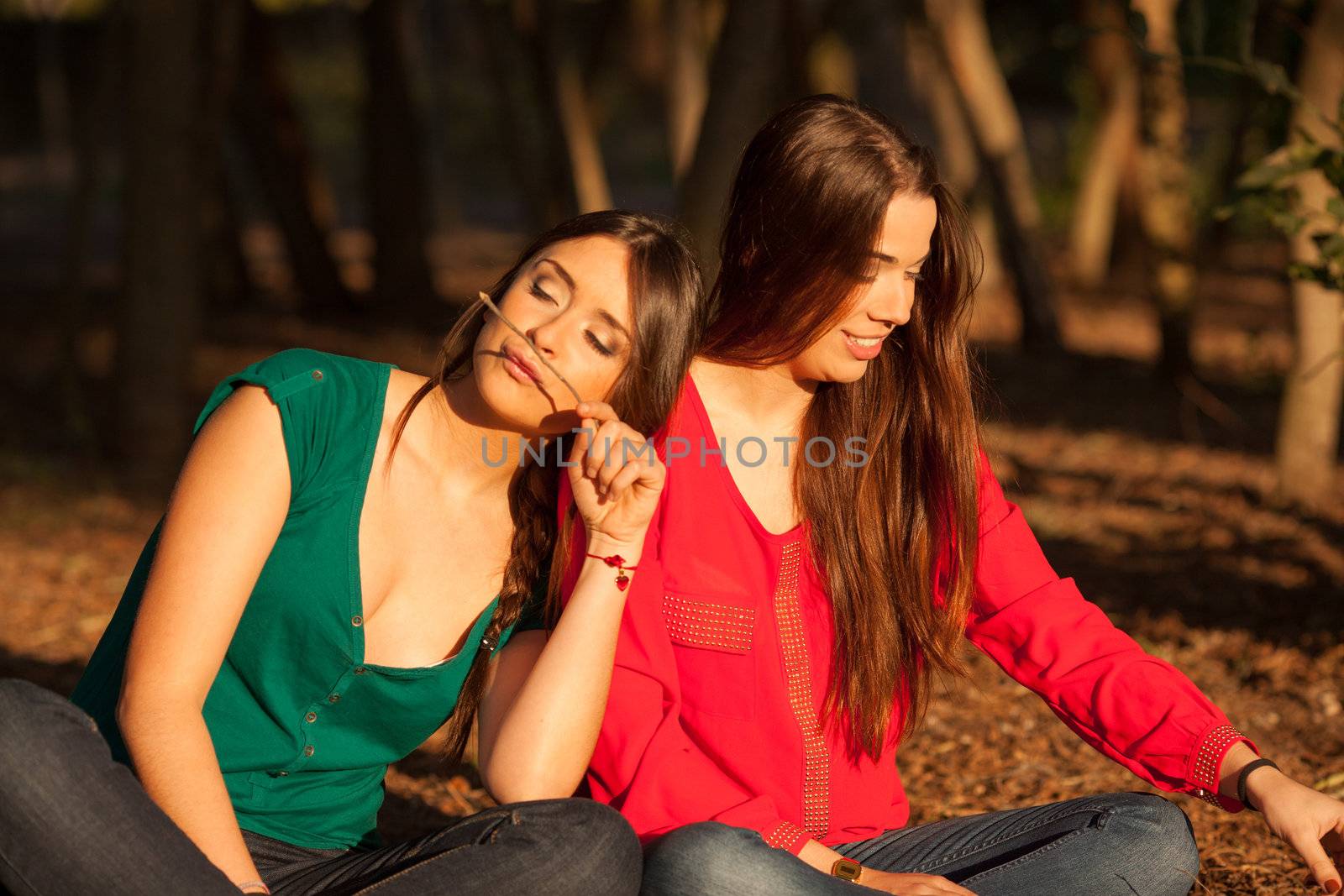 young girlfriends playing on a park by Lcrespi