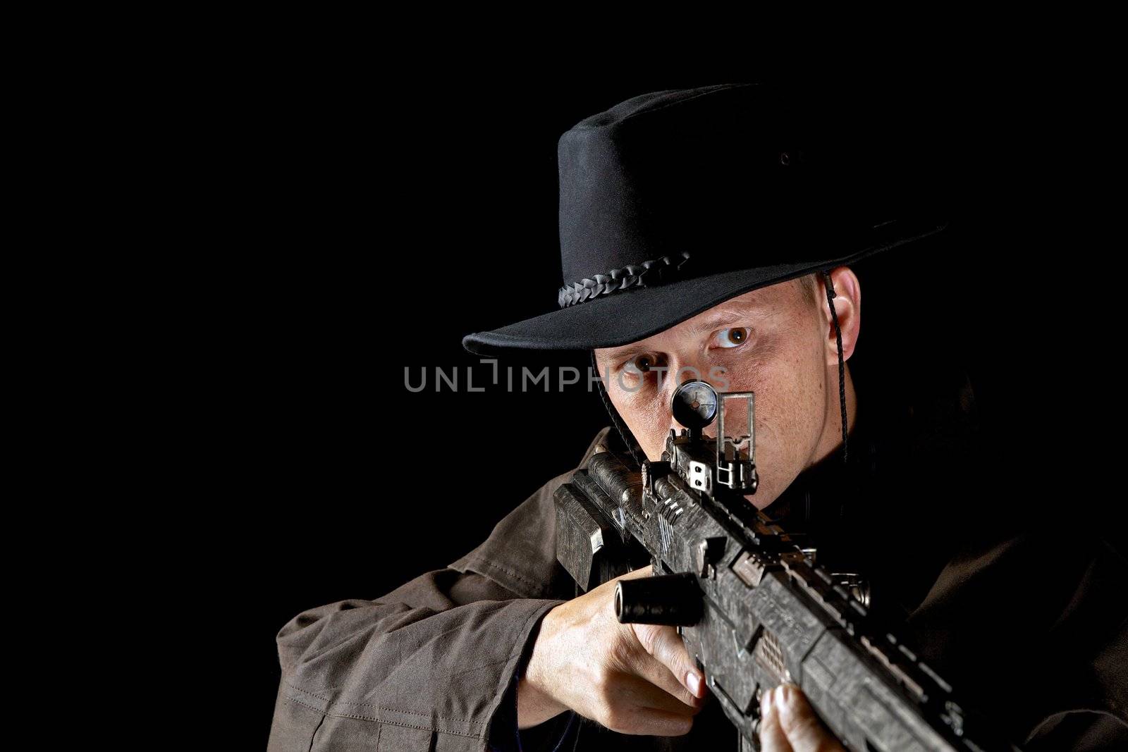 Landscape portrait of male with rifle