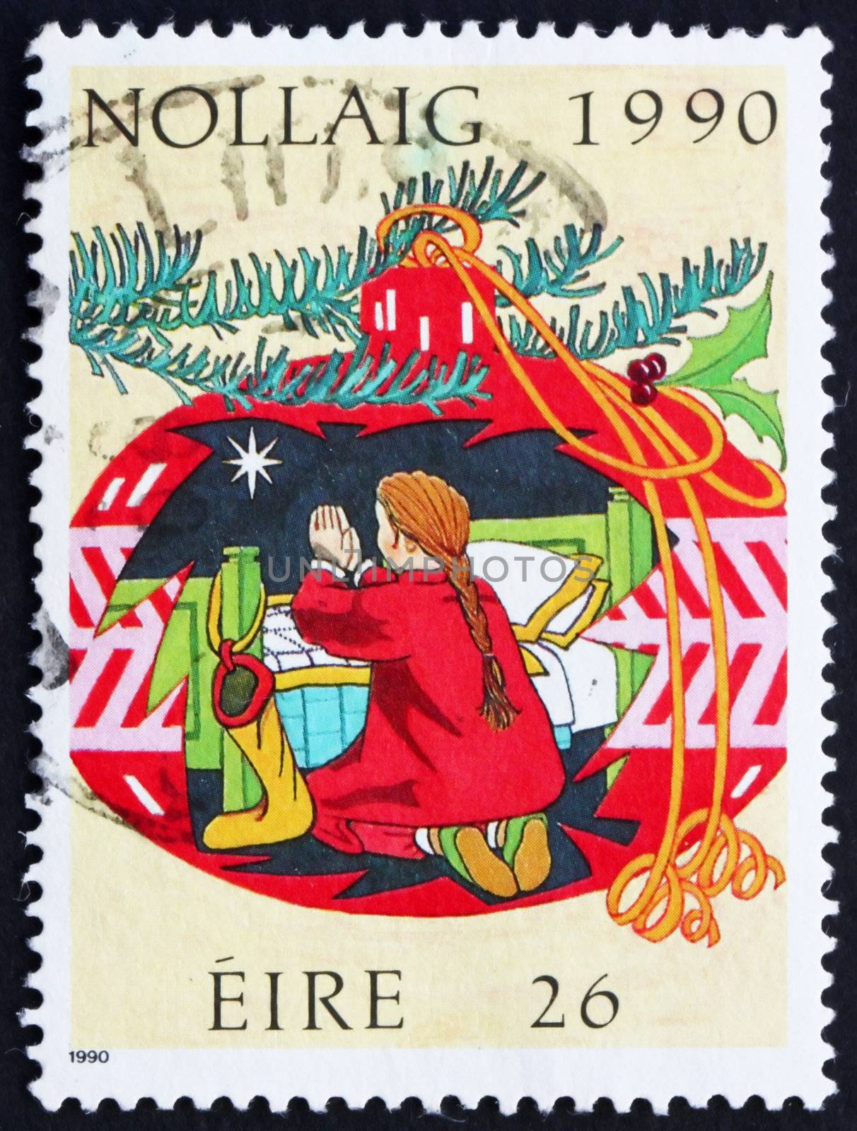 IRELAND - CIRCA 1990: a stamp printed in the Ireland shows Child Praying in a Christmas Decoration, Christmas, circa 1990