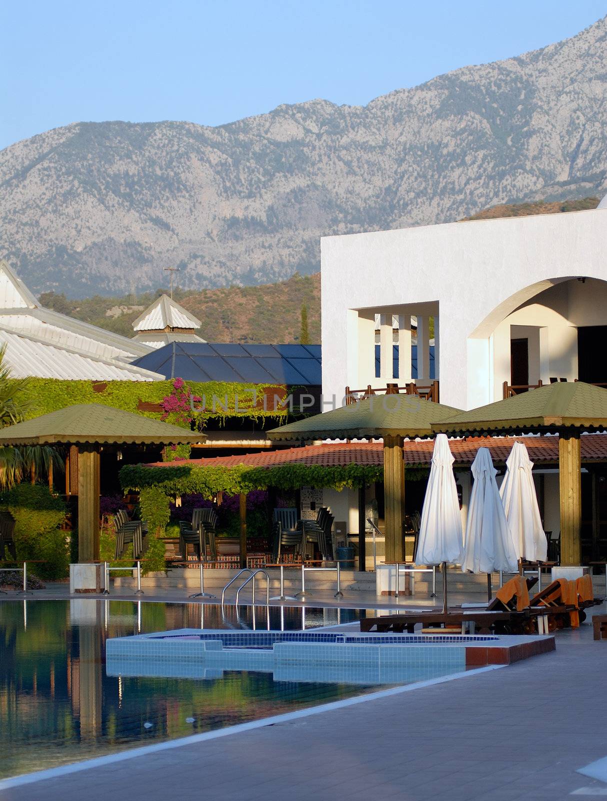 beautiful swimming pool with parasols and view to mountain