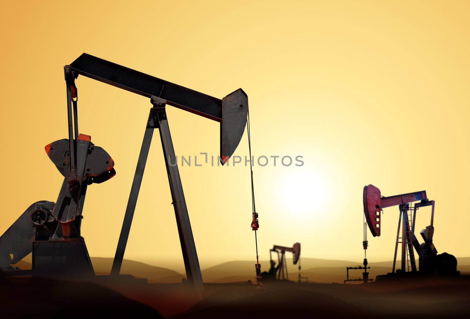 Working oil pump in deserted district at sunset