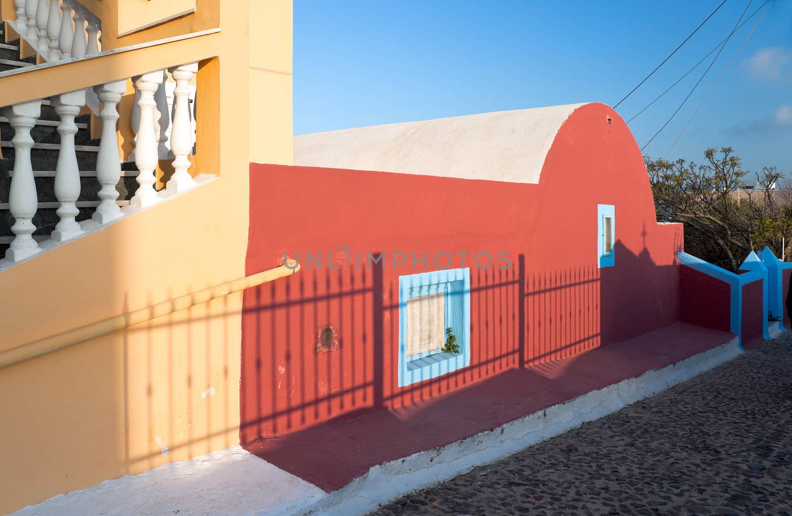Yellow staircase and the red building in Santorini island