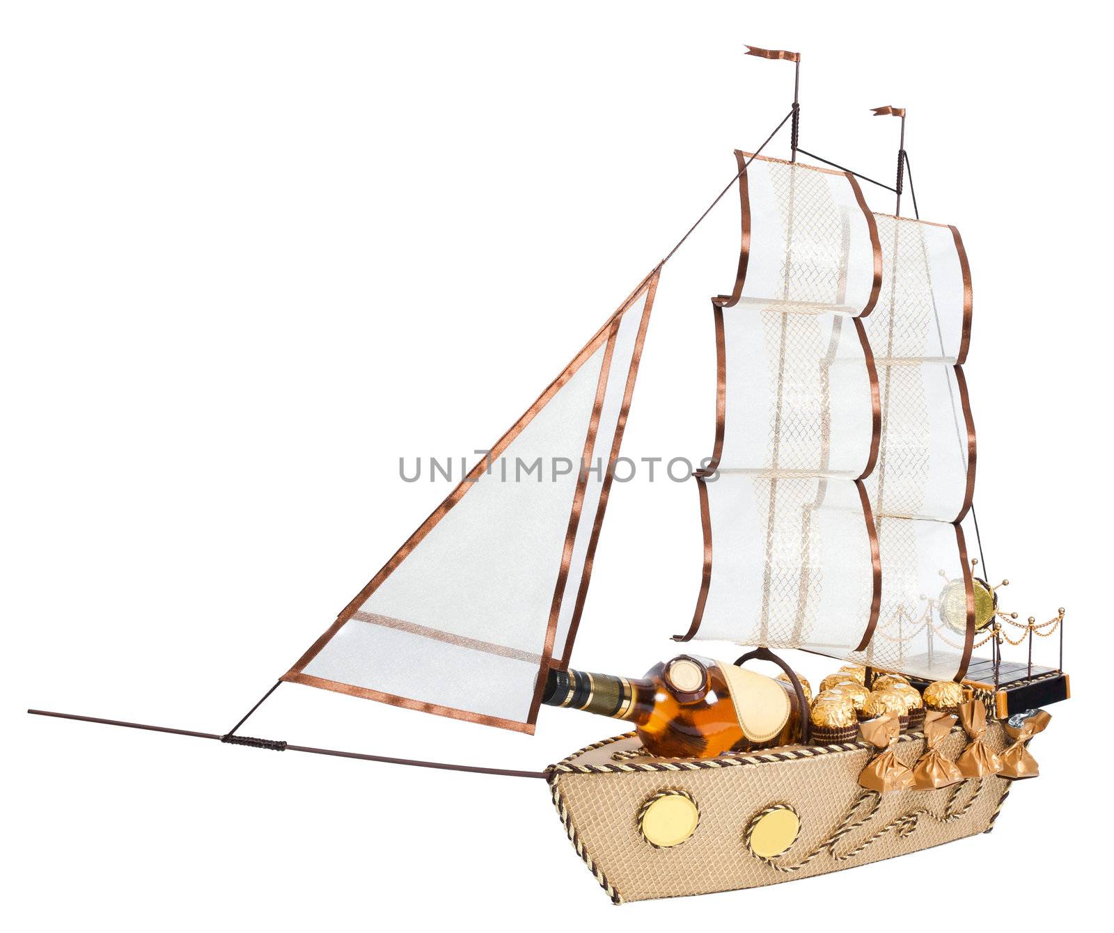 gift in form layout sailing ship decorated with candy isolated on white