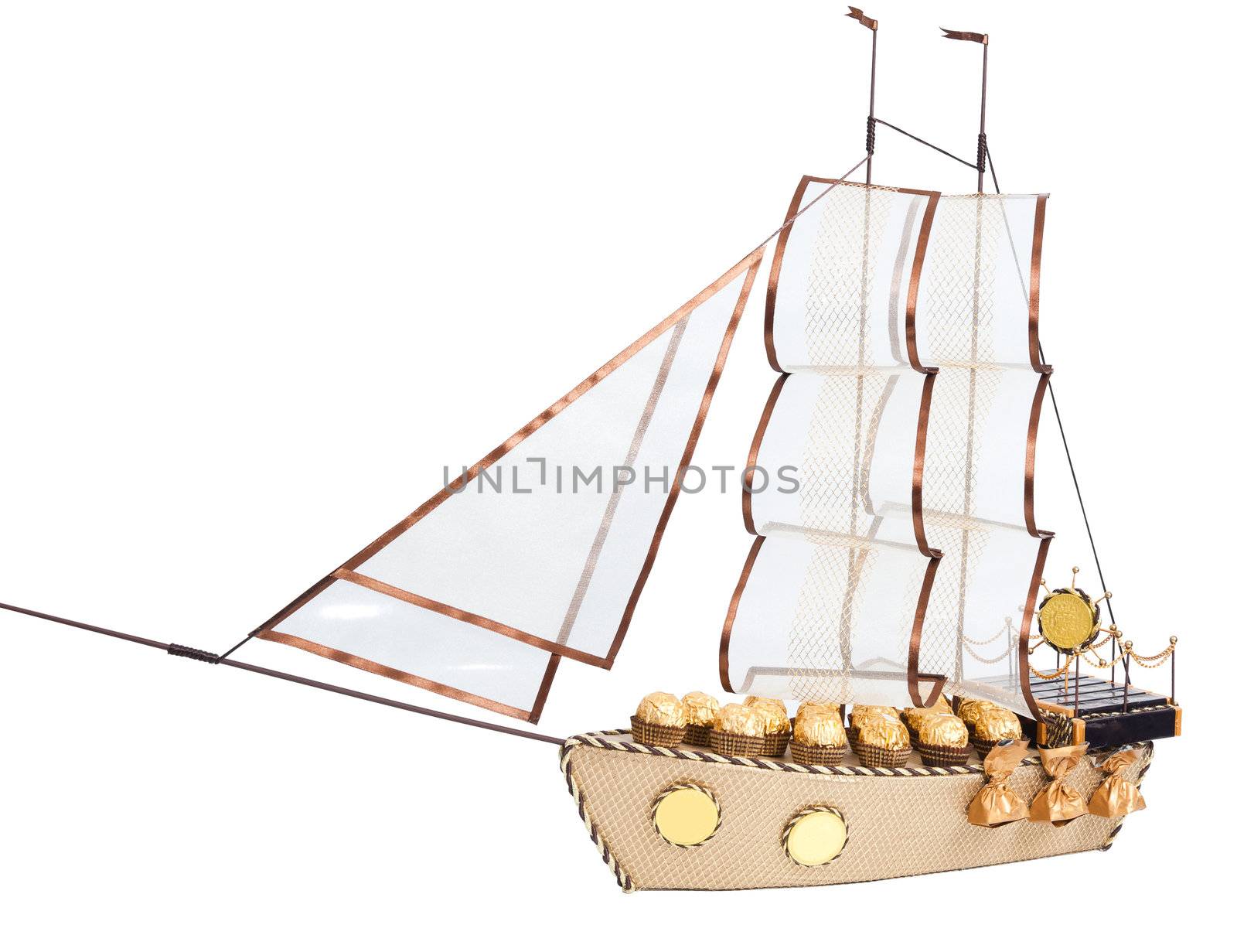 gift in form layout sailing ship decorated with candy isolated on white