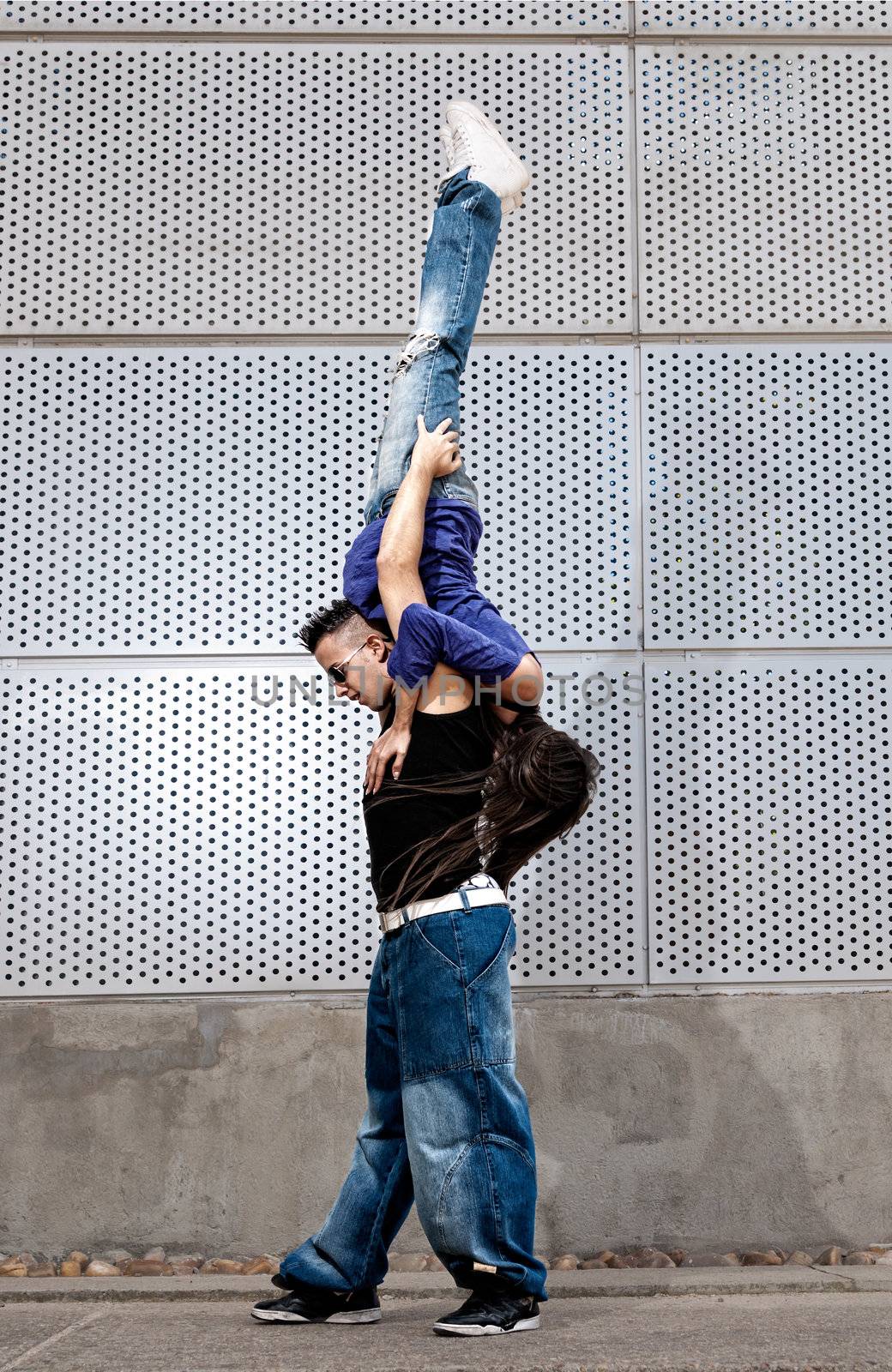 Young urban couple dancers hip hop dancing urban scene by dgmata