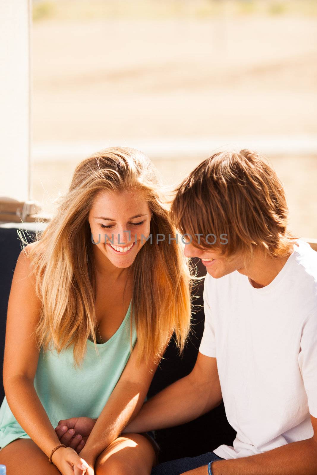 Young beautiful couple having fun in a beach bar