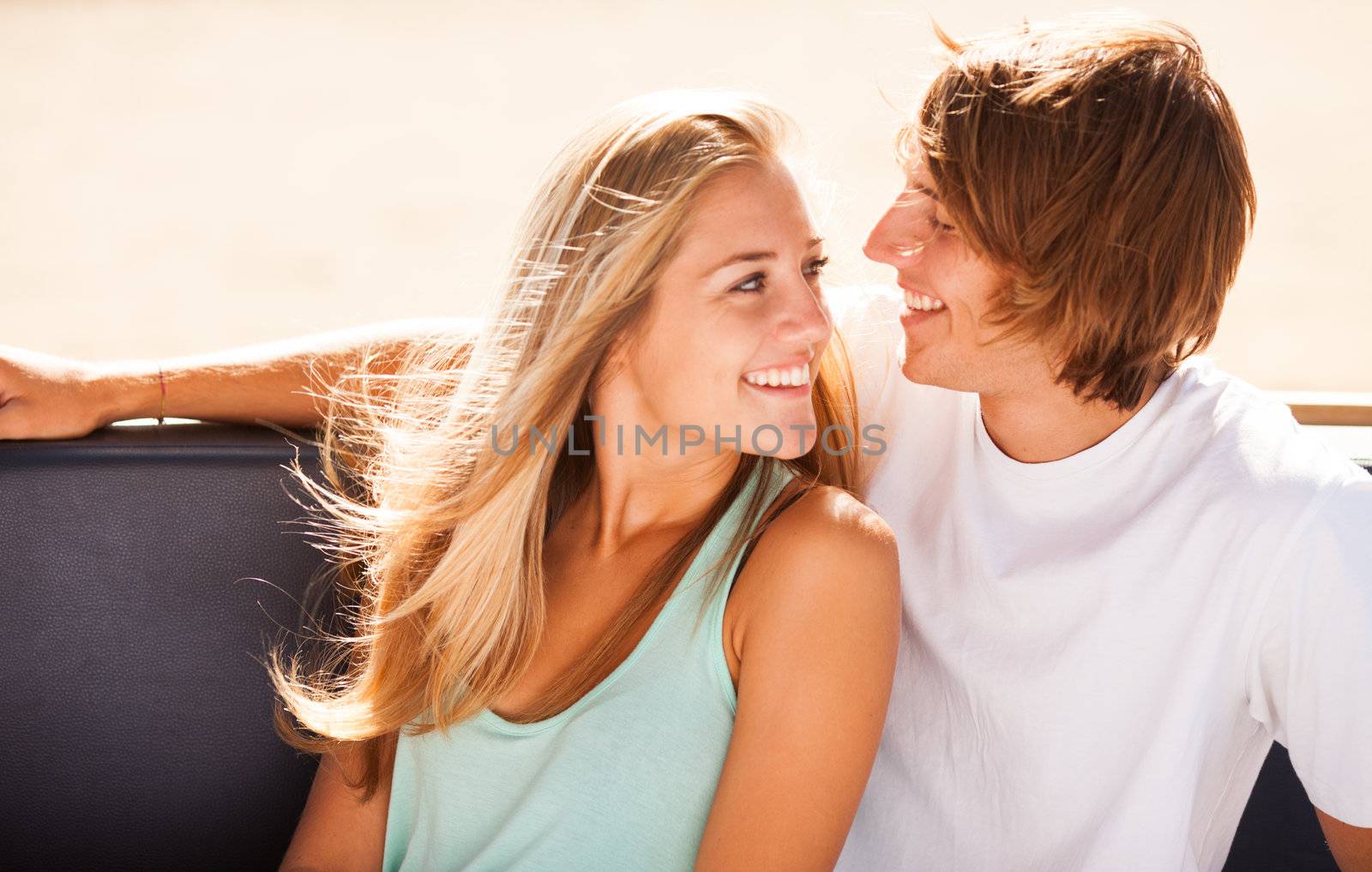 Young beautiful couple having fun in a beach bar