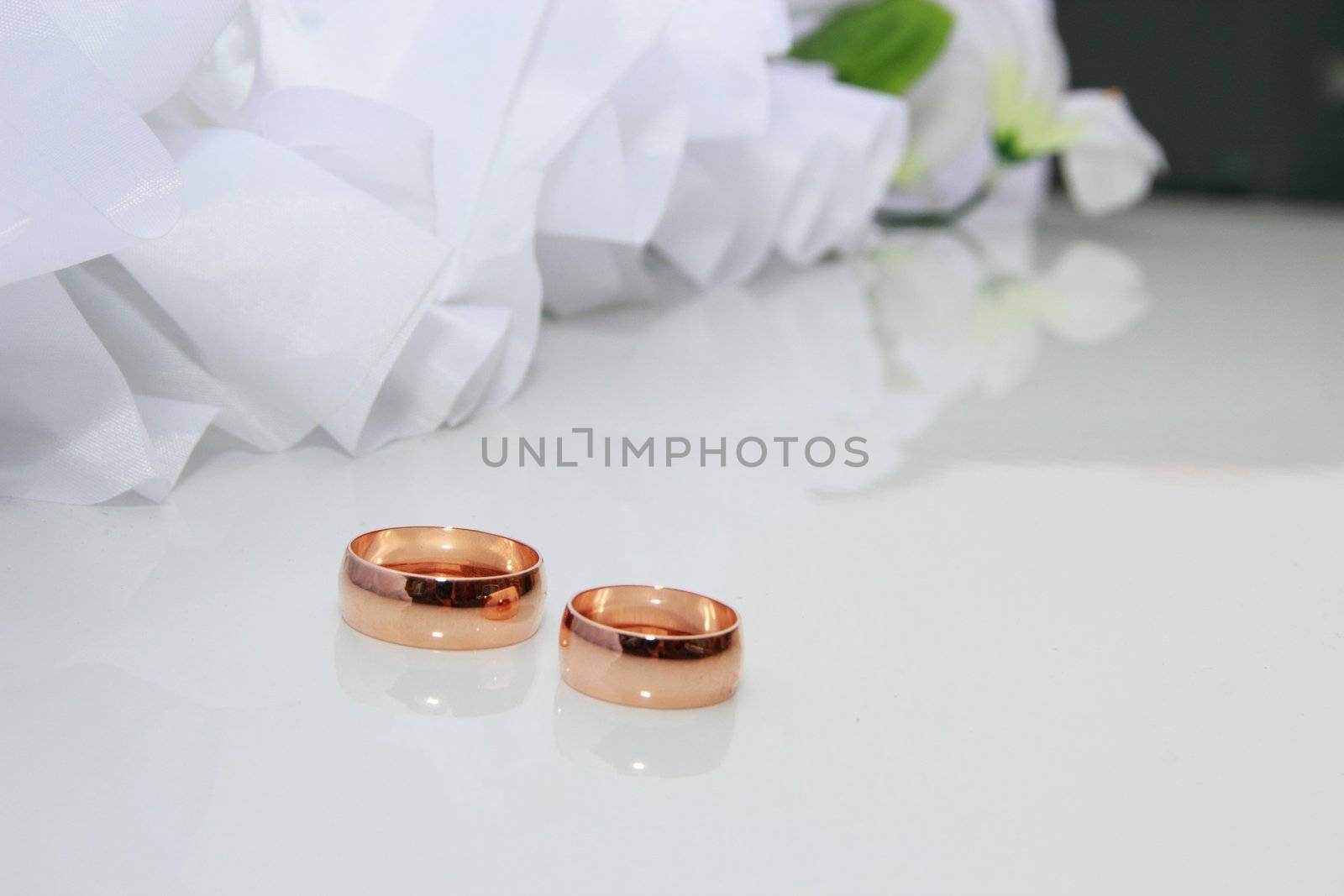 Wedding rings on a white background with wedding decorationsding Rings