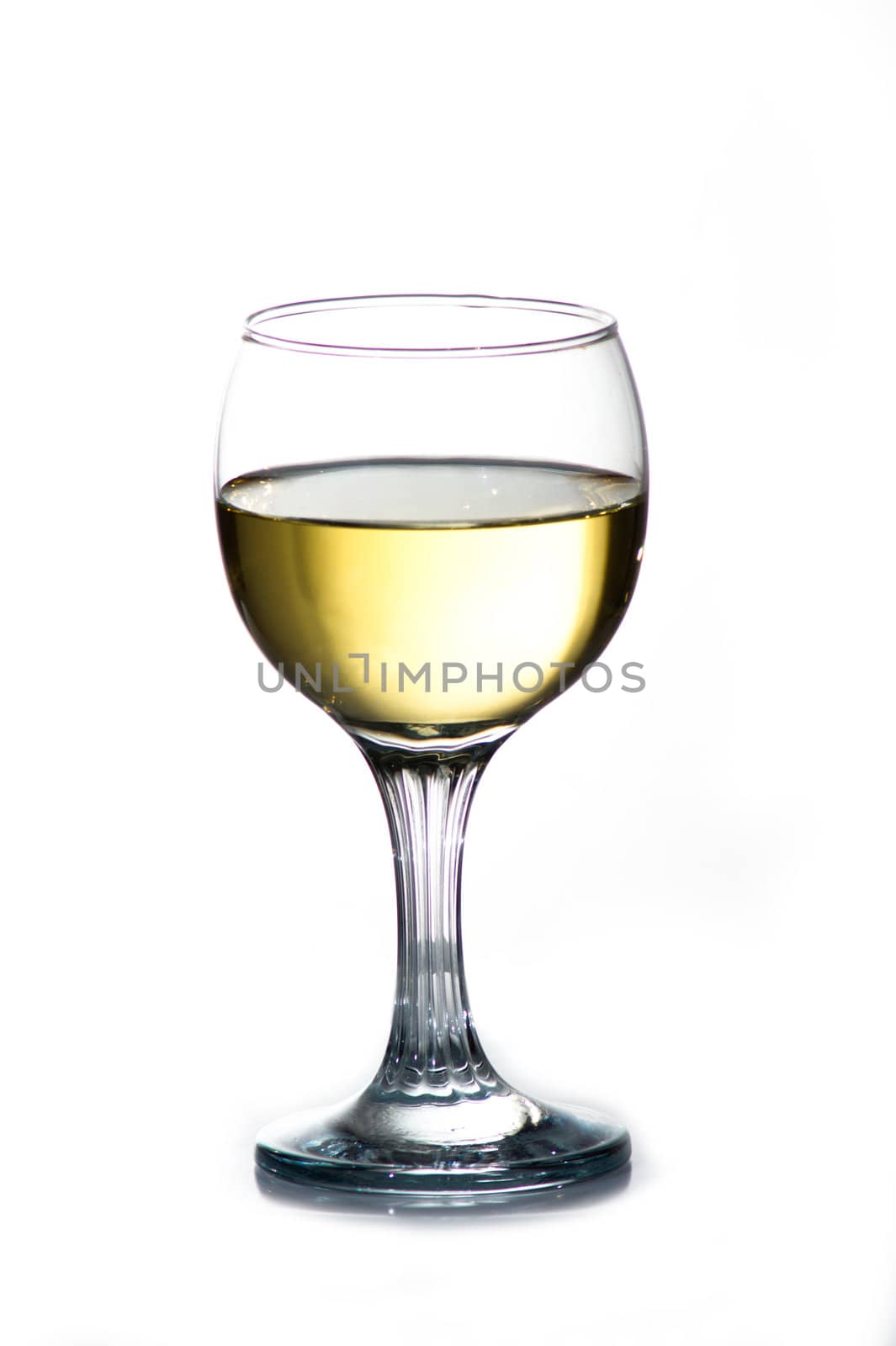 Wineglass with cold white wine. Isolated.
